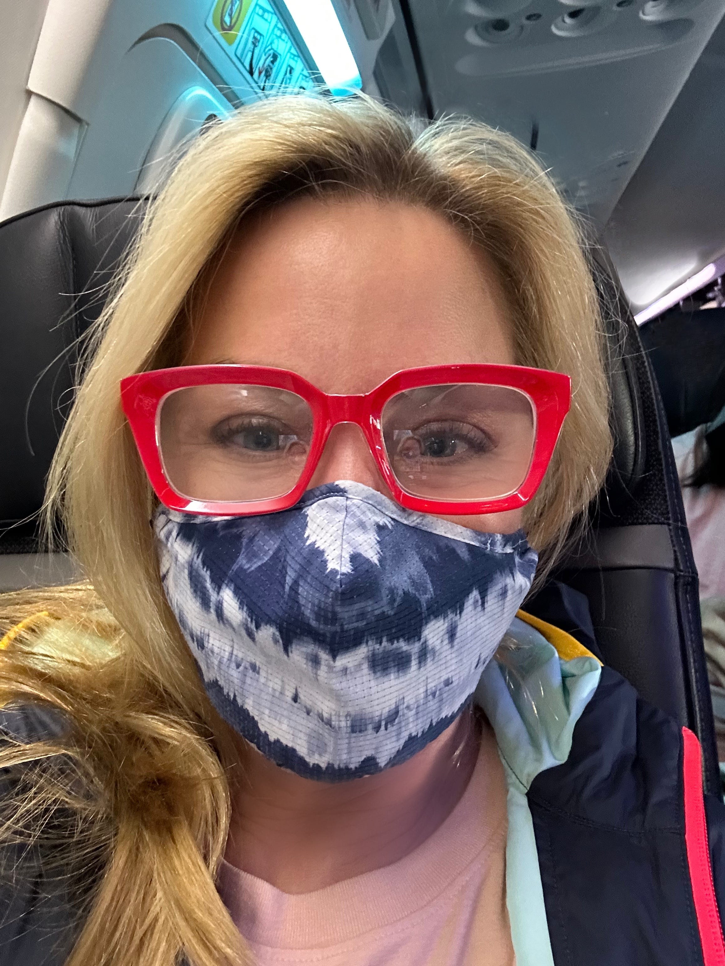 Making sure to wear a mask while flying days after being diagnosed with COVID,