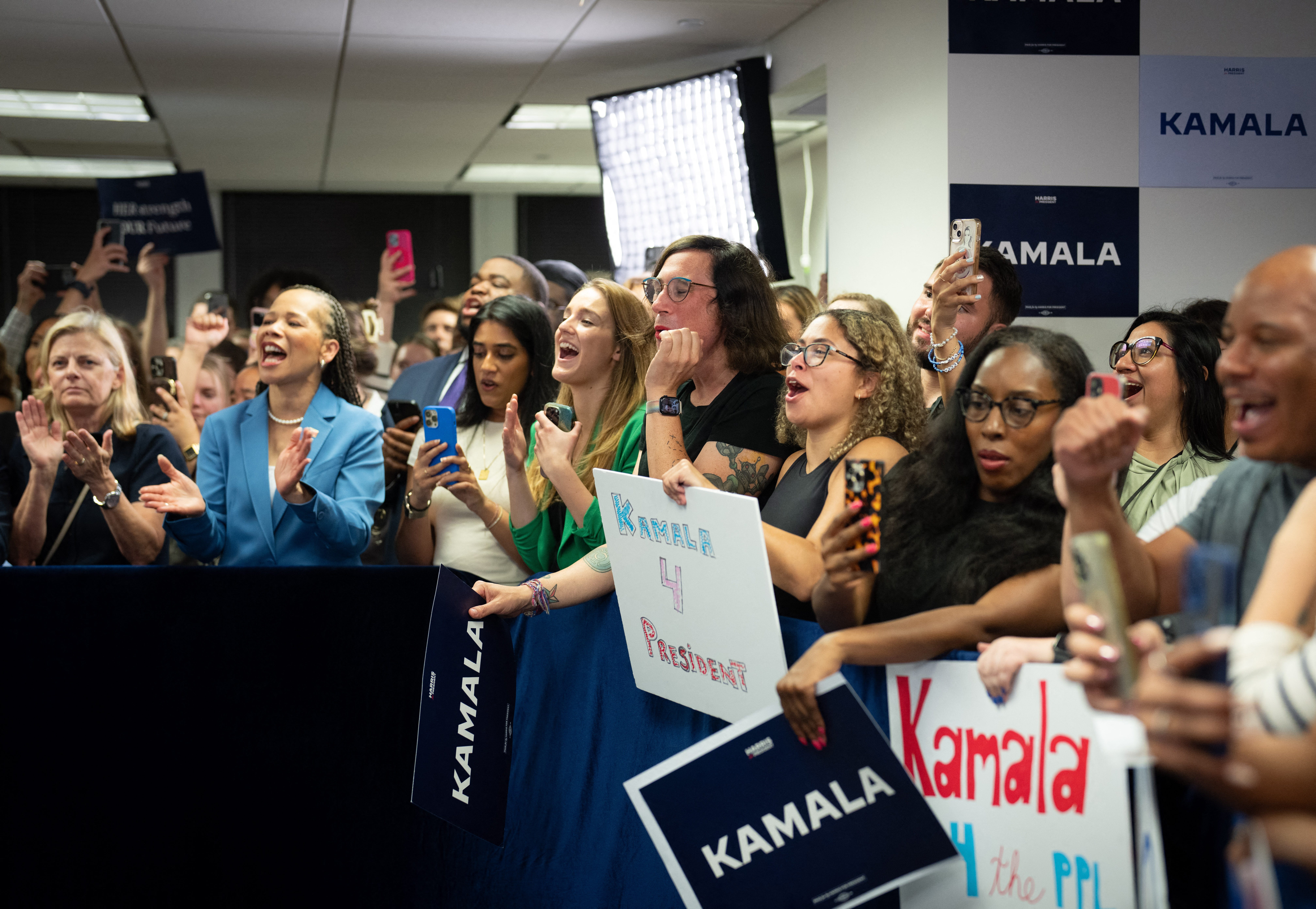 Staff cheers as Vice President Kamala Harris visits her presidential campaign headquarters in Wilmington, Del., on July 22, 2024.