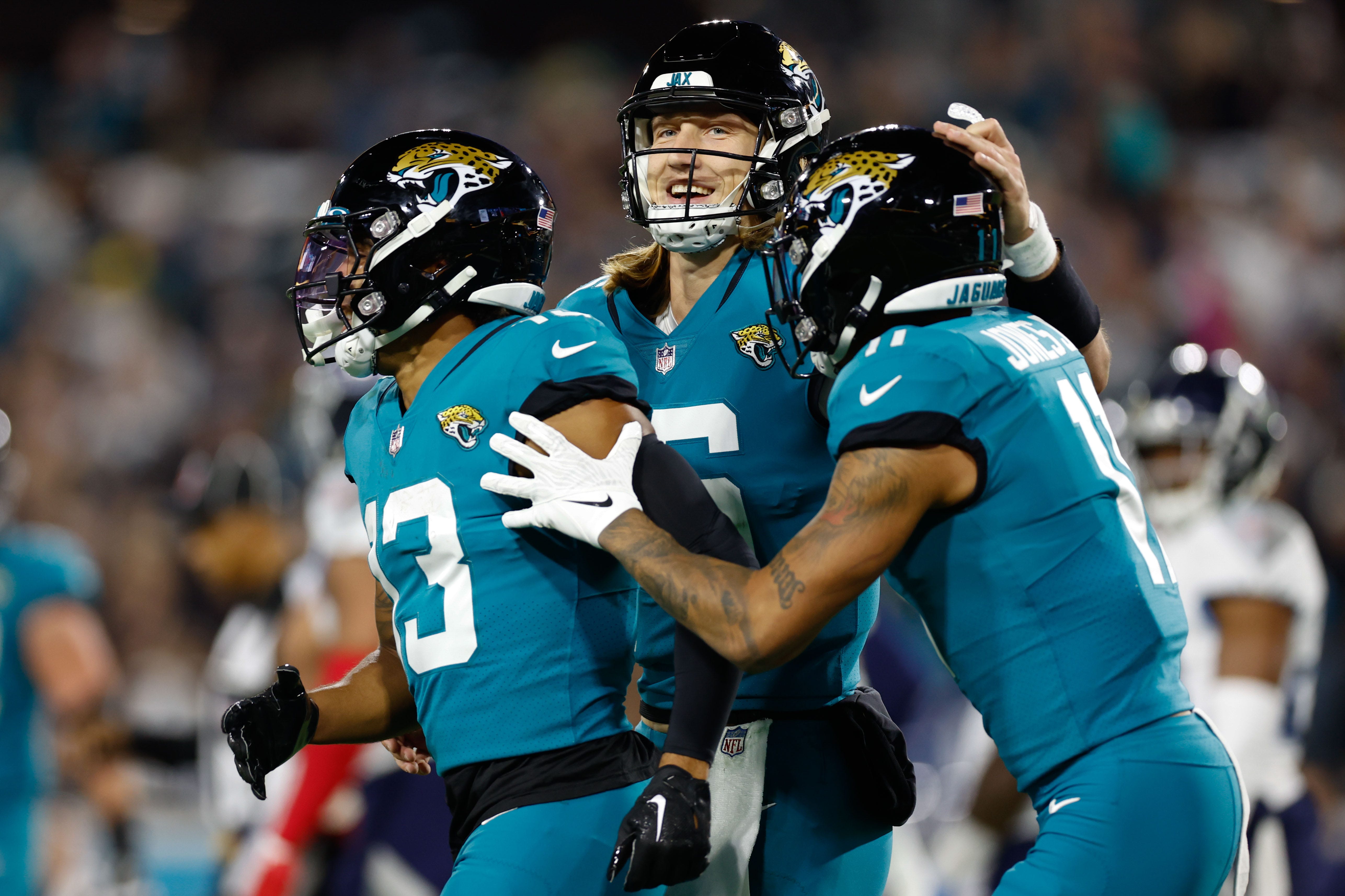 Jacksonville Jaguars wide receiver Christian Kirk (13) celebrates with teammate quarterback Trevor Lawrence (16) after scoring a touchdown against the Tennessee Titans at TIAA Bank Field.