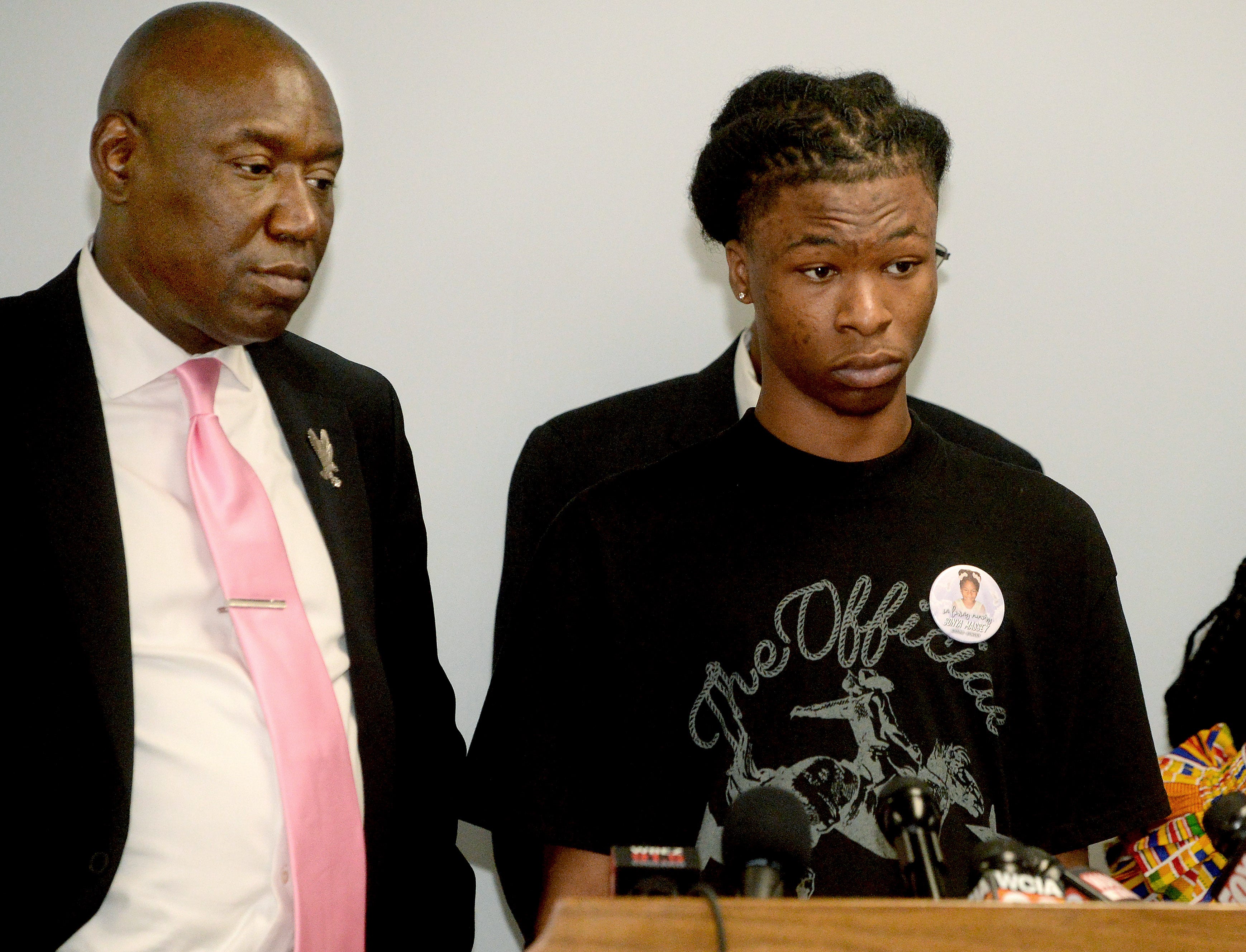 Son of Sonya Massey, Malachi Hill, right, stands next to civil rights attorney Ben Crump, as Hill talks about his mother and what happen the day she was shot and killed during a press conference at the NAACP building in Springfield on July 26, 2024.