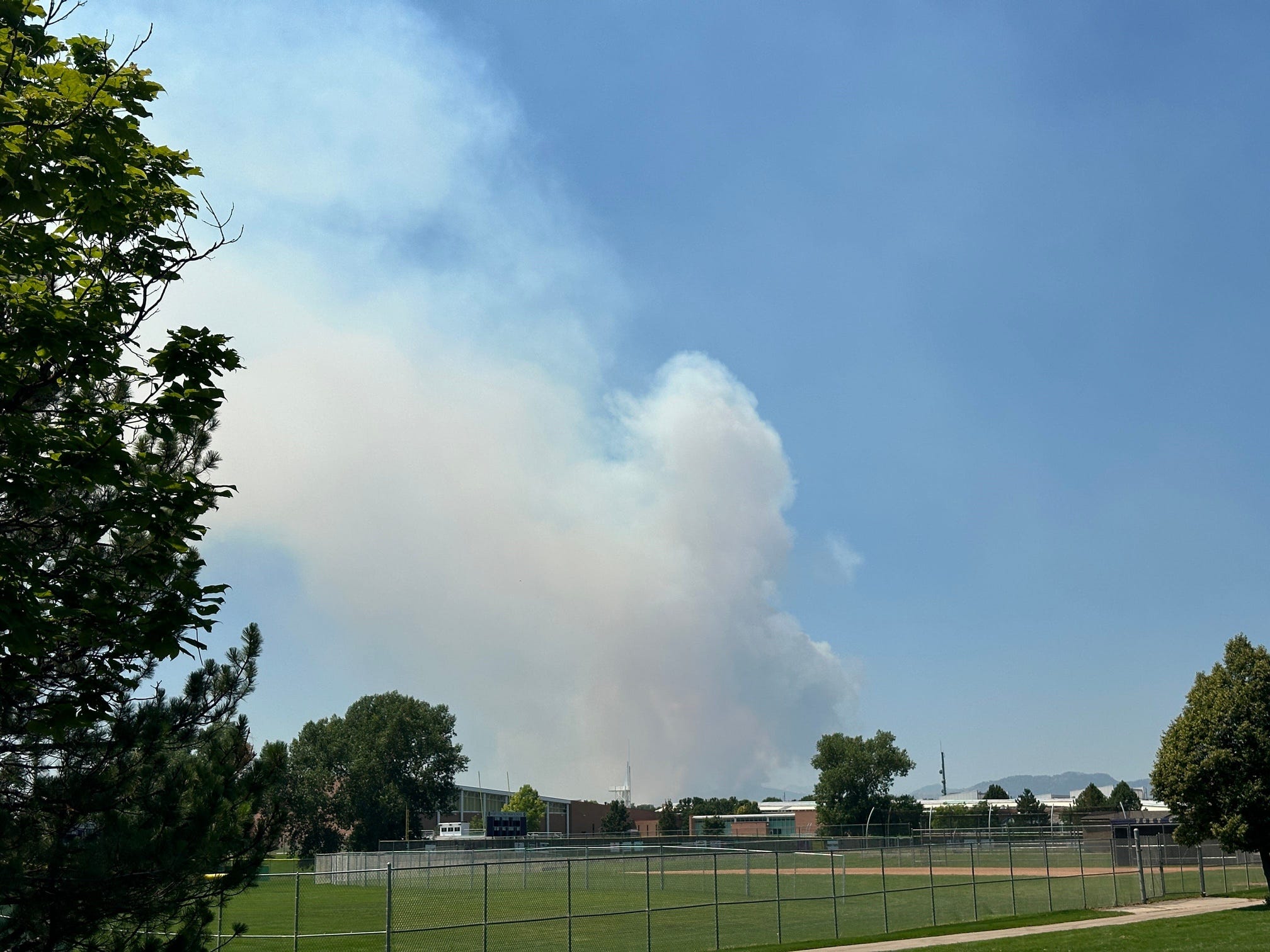 A big smoke plume appears northeast of Fort Collins High School in direction of Loveland, Colorado on July 29, 2024.
