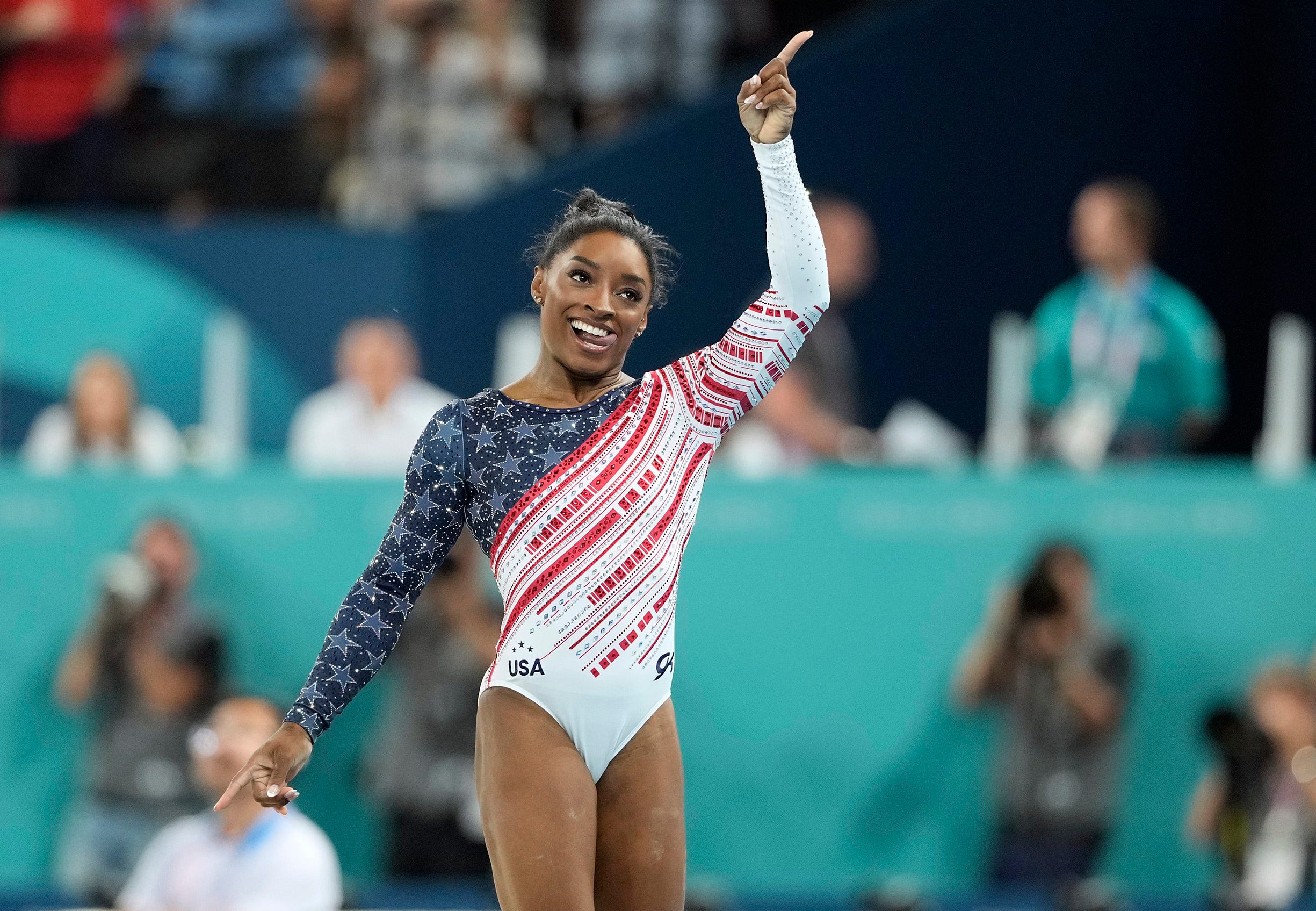 Simone Biles of the United States holds up the number one after the women's team final at the 2024 Paris Olympics.