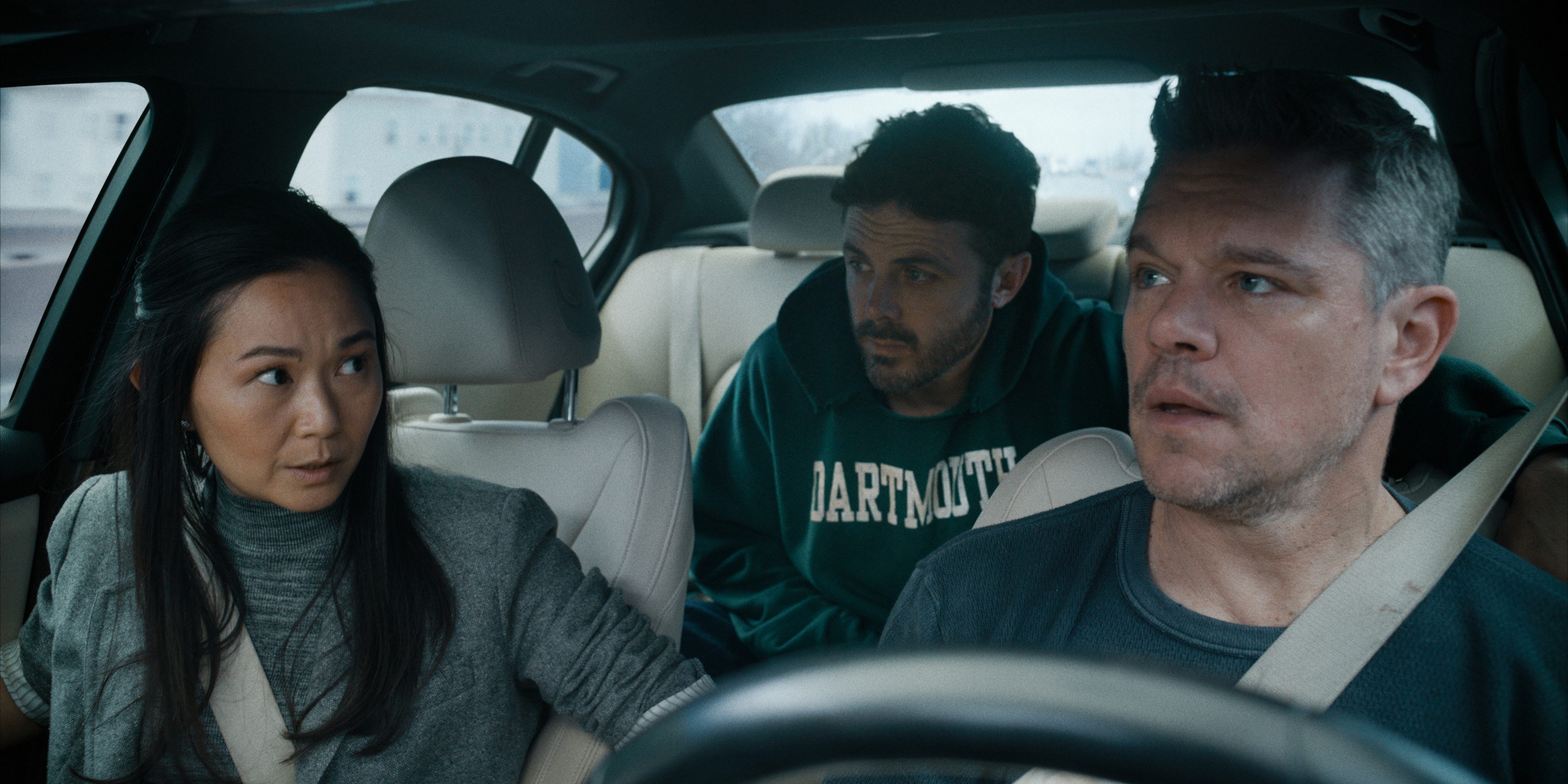 Hong Chau (left), Casey Affleck (in the back seat) and Matt Damon conduct a therapy session in the middle of a car chase in "The Instigators," a new comedy caper film from Apple TV+.