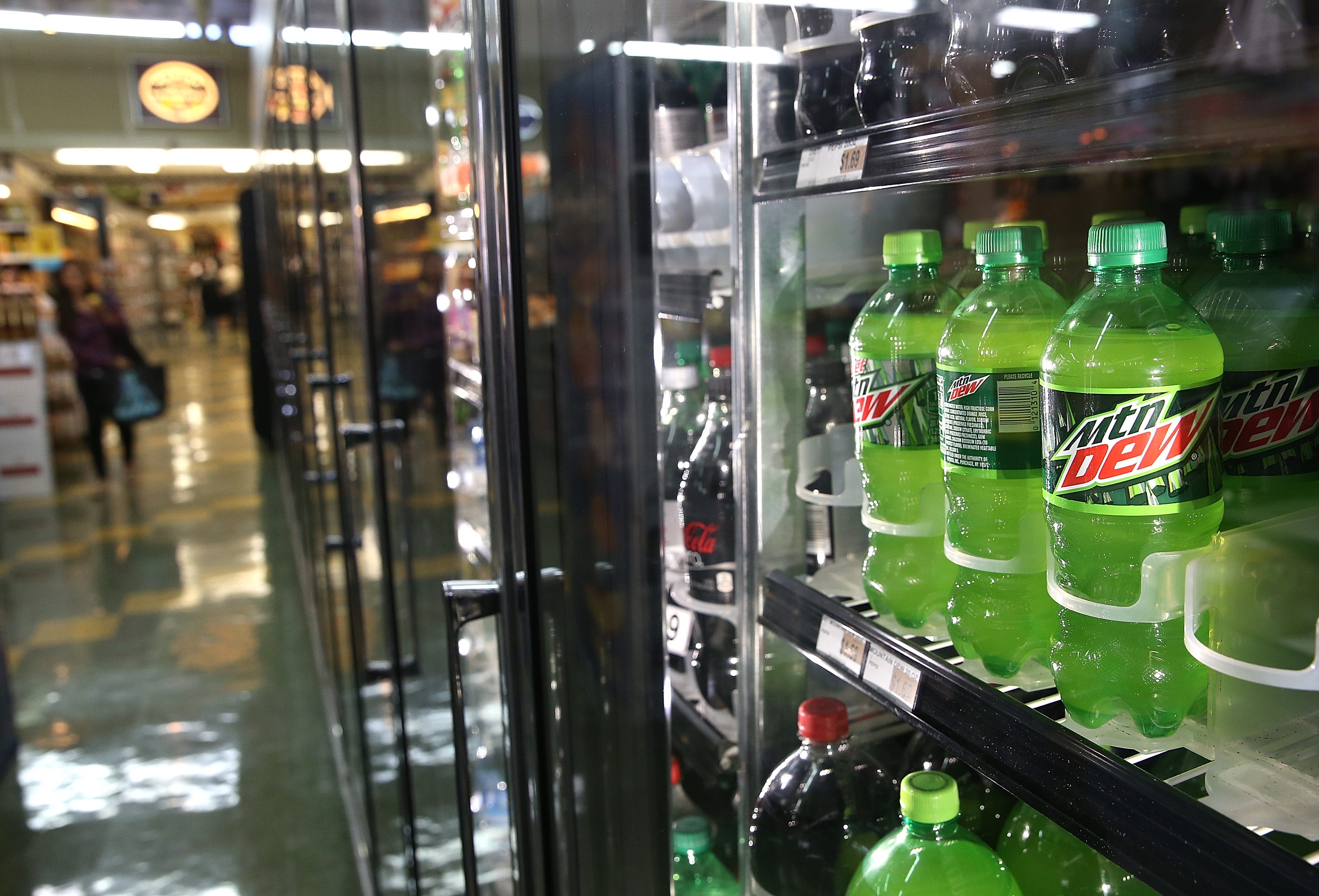 Bottles of Mountain Dew are displayed in a cooler at Marina Supermarket in San Francisco, California.