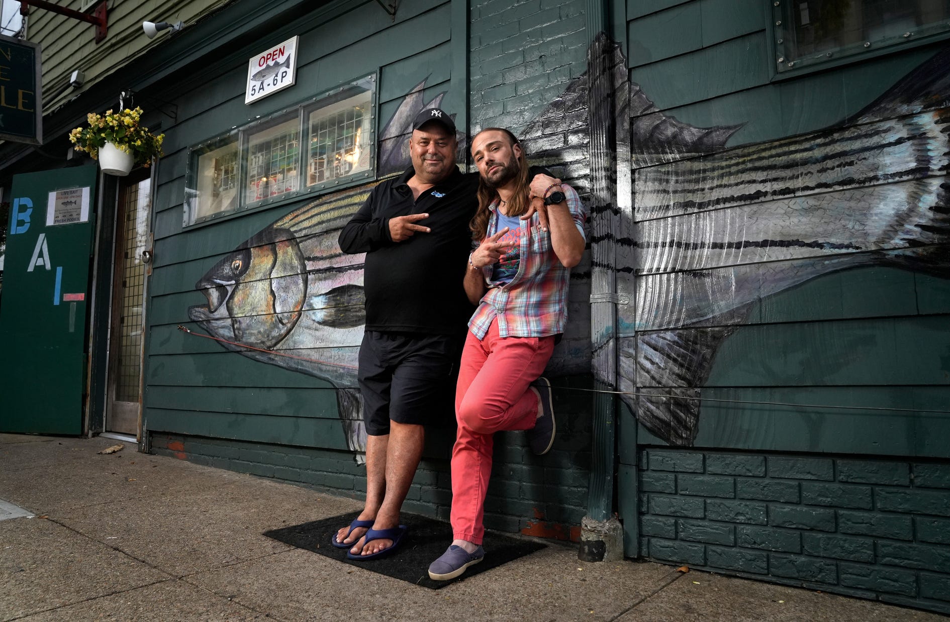 Dave Henault, longtime owner of Ocean State Tackle in Providence, stands outside his shop with his nephew and godson, Andrew Reinhardt, in August. Reinhardt donated a kidney to his uncle. Both are doing well after the surgeries.