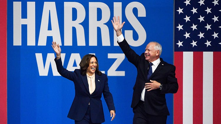 Democratic presidential nominee Kamala Harris enters the stage with her running mate, Minnesota Gov. Tim Walz, at a campaign rally in Philadelphia on Aug. 6, 2024.