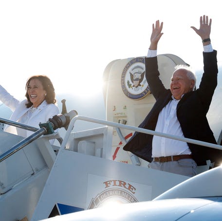 2024 Democratic presidential nominee Kamala Harris and running mate Tim Walz disembark Air Force Two for a campaign rally in Romulus, Michigan, on Aug. 7, 2024.