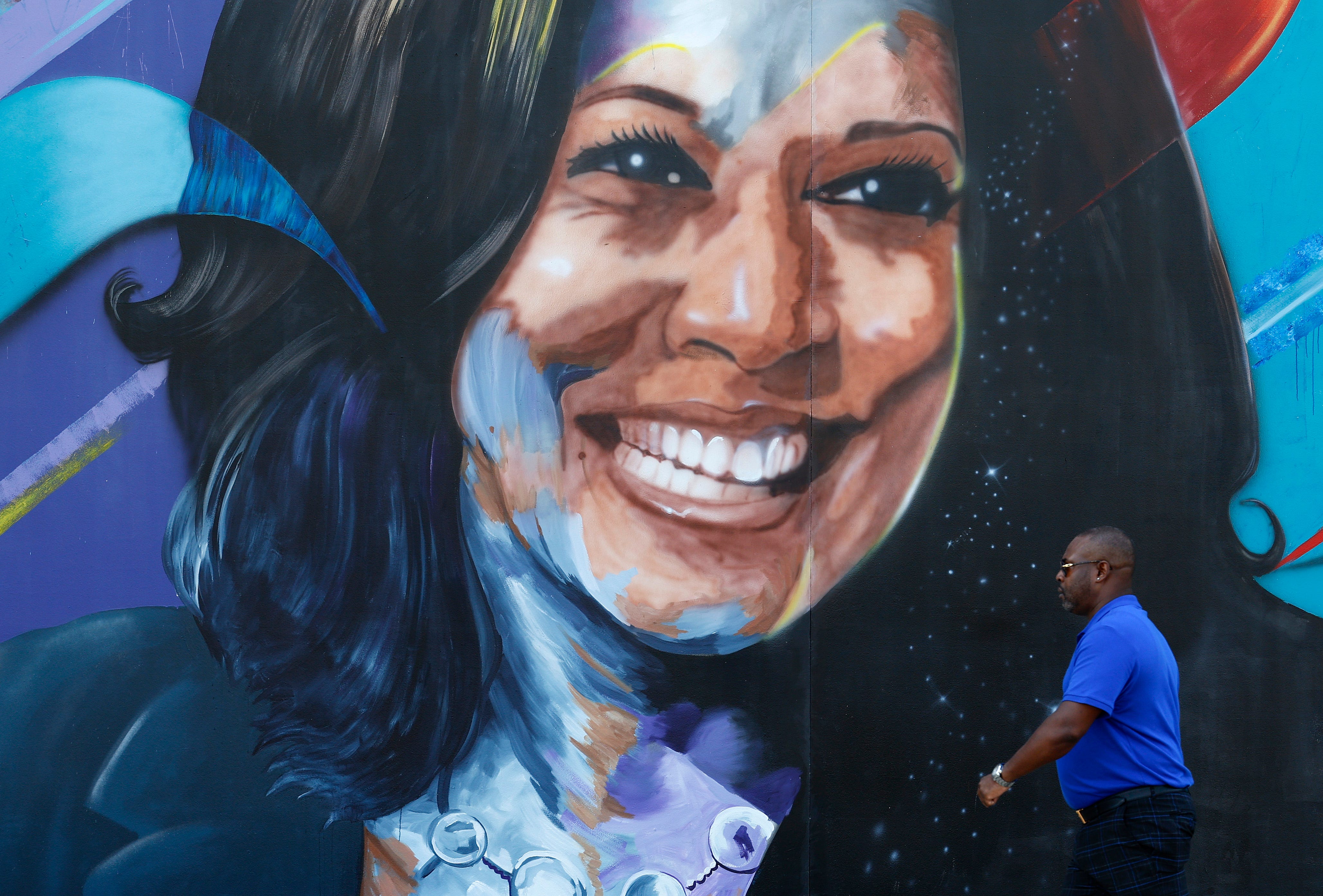 A person walks past a mural of Democratic presidential nominee Vice President Kamala Harris outside of the United Center on August 16, 2024 in Chicago, Illinois.