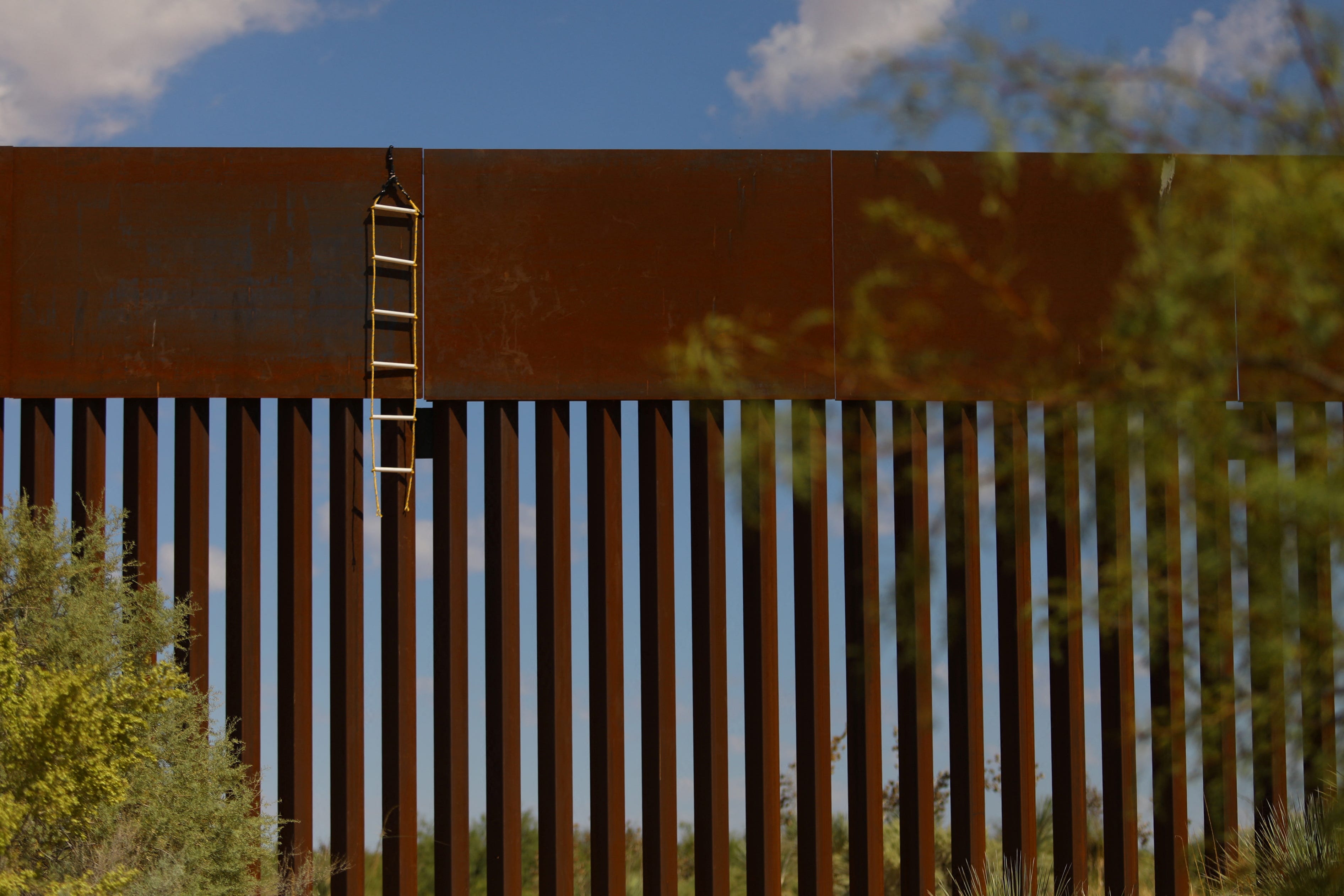 A ladder used by migrants to cross into the United States from Mexico hangs from the border wall on the outskirts of Ciudad Juarez, Mexico, September 15, 2023. REUTERS/Jose Luis Gonzalez