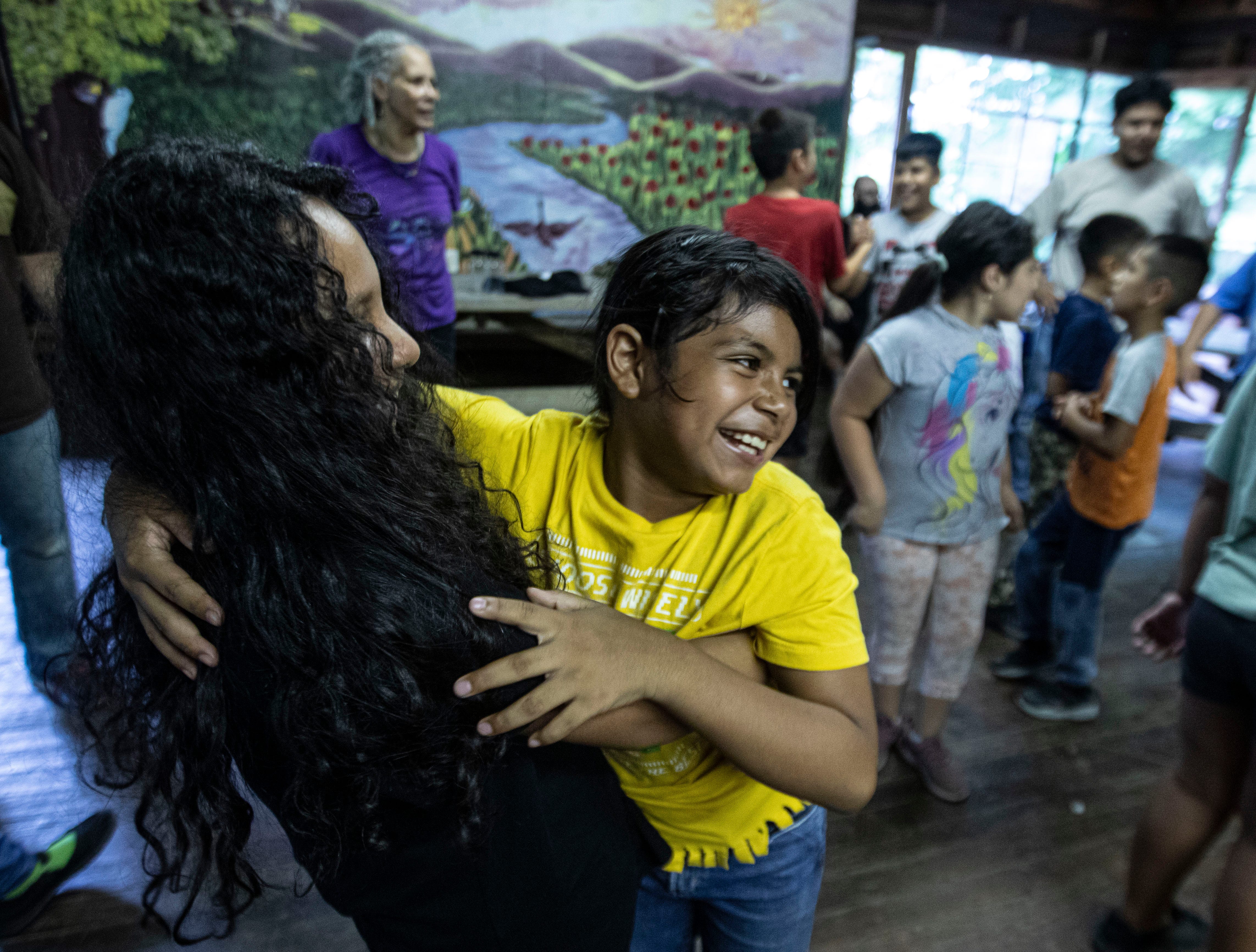 Valentina, 9, and Oneida, 10, campers at the Summer Overnight Leadership Camp in Holmes, N.Y. embrace as they partner with each other during an activity Aug. 19, 2024. The one-week camp, which is run by the Rural & Migrant Ministry, serves the children of migrant workers and immigrant families.