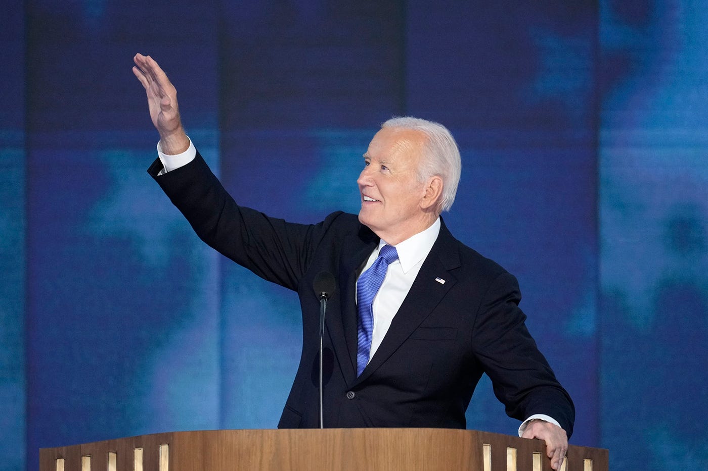 President Joe Biden takes the stage for his speech during the first night of the Democratic National Convention in Chicago on Aug. 19, 2024.