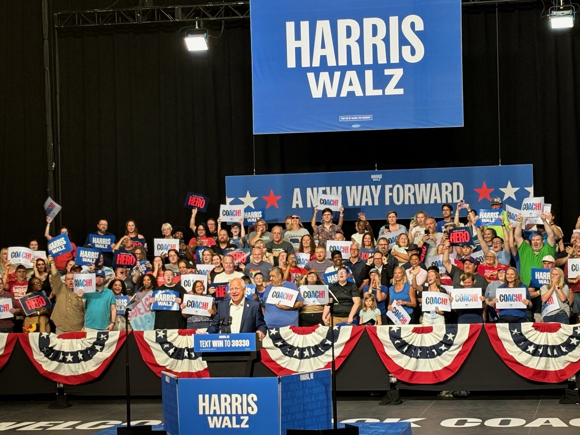 Democratic vice presidential pick and Minnesota Gov. Tim Walz speaks to a crowd at a rally in La Vista, Neb. Saturday.