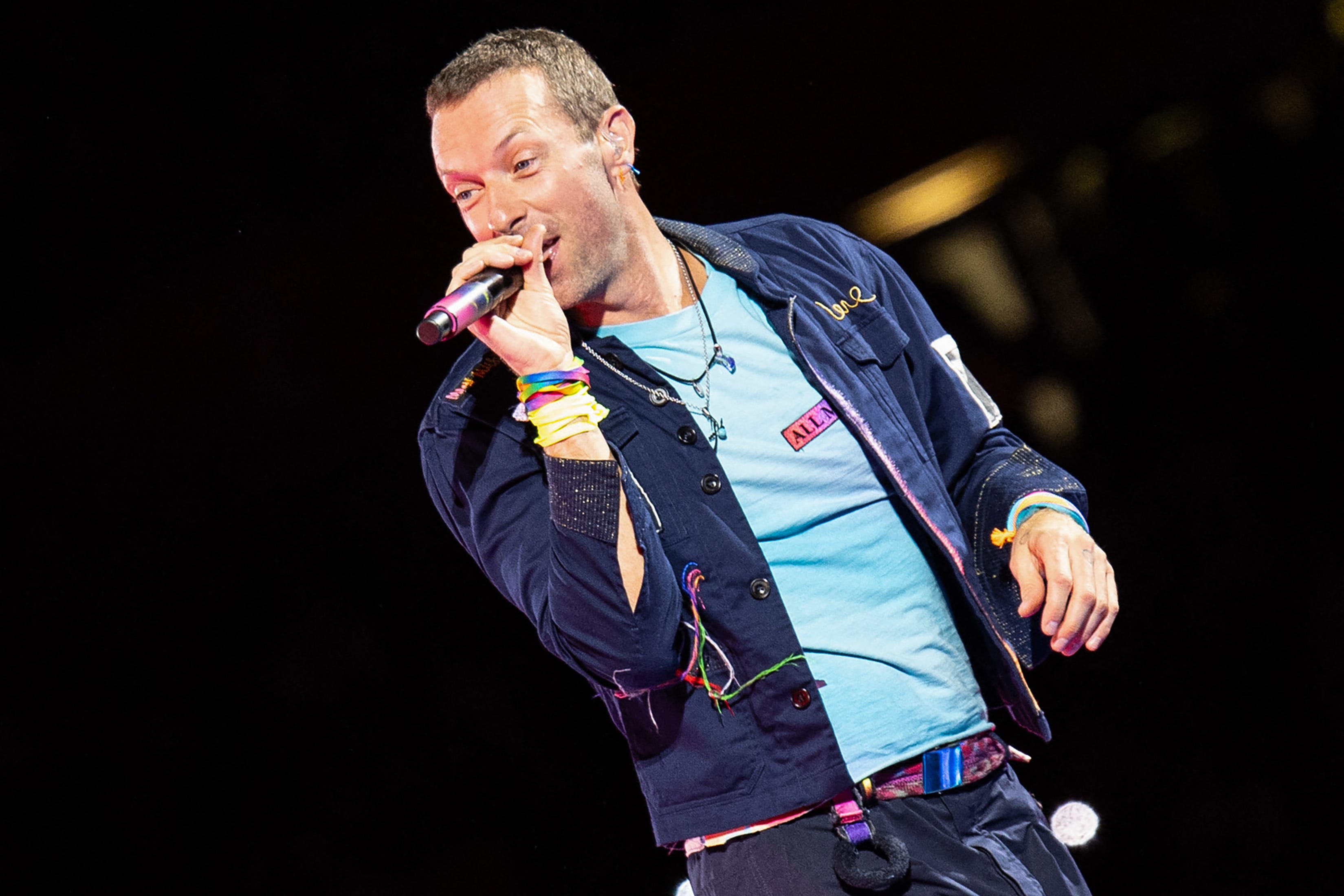 Singer Chris Martin of British rock band Coldplay performs on stage during a concert at the Ernst Happel Stadium in Vienna, Austria on August 21, 2024. Security measures have been tightened in Vienna for a series of concerts by British band Coldplay this week, Austrian police said on August 20, 2024, after Taylor Swift's shows were cancelled after a suicide bombing plot. (Photo by TOBIAS STEINMAURER / APA / AFP) / Austria OUT / RESTRICTED TO EDITORIAL USE AND SOLELY IN   RELATION WITH THE EVENT (Photo by TOBIAS STEINMAURER/APA/AFP via Getty Images) ORIG FILE ID: 2167087617