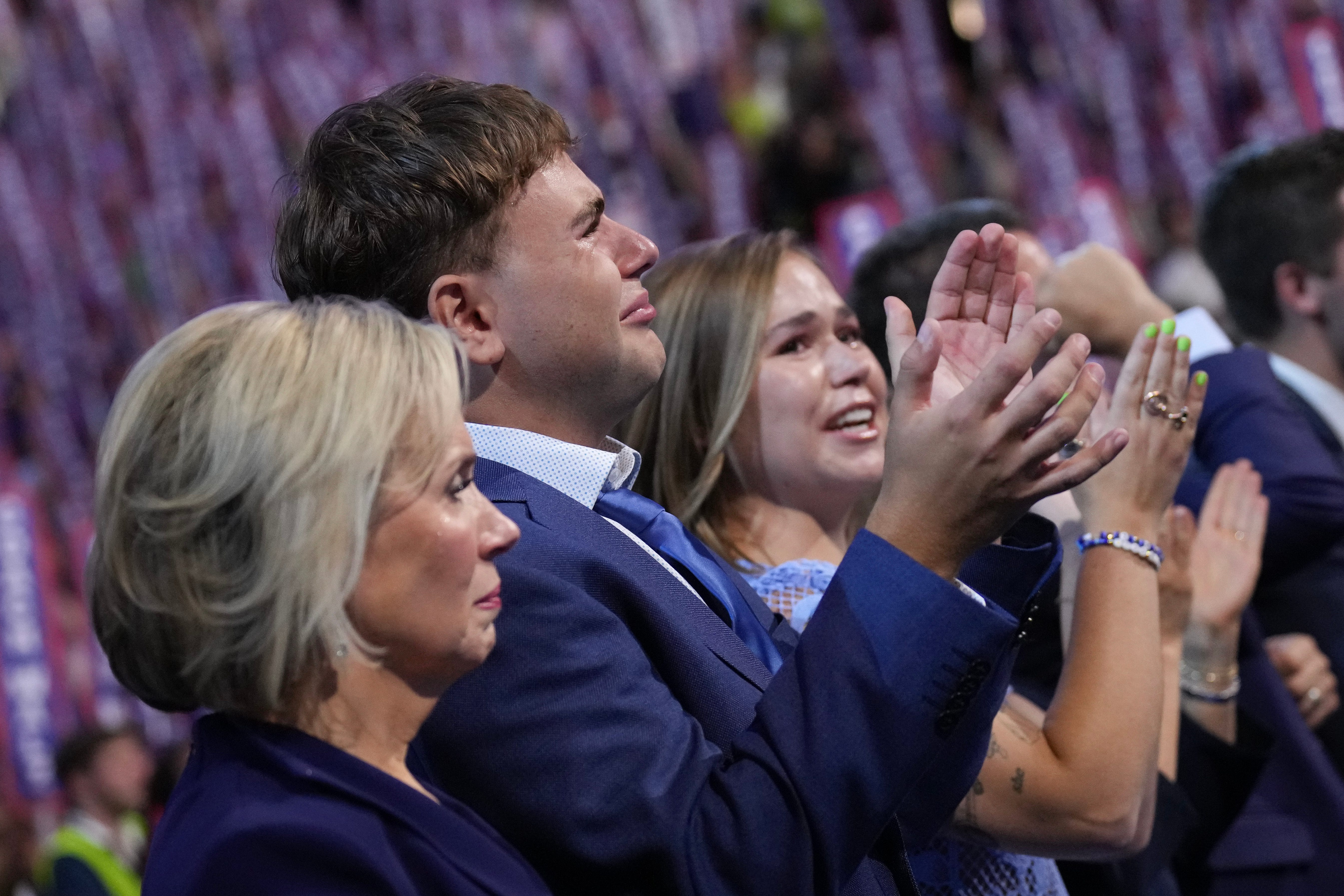 From left, Minnesota first lady Gwen Walz and her children, Gus and Hope, cheer on Democratic vice presidential nominee Gov. Tim Walz addressing the Democratic National Convention in Chicago on Aug. 21, 2024.
