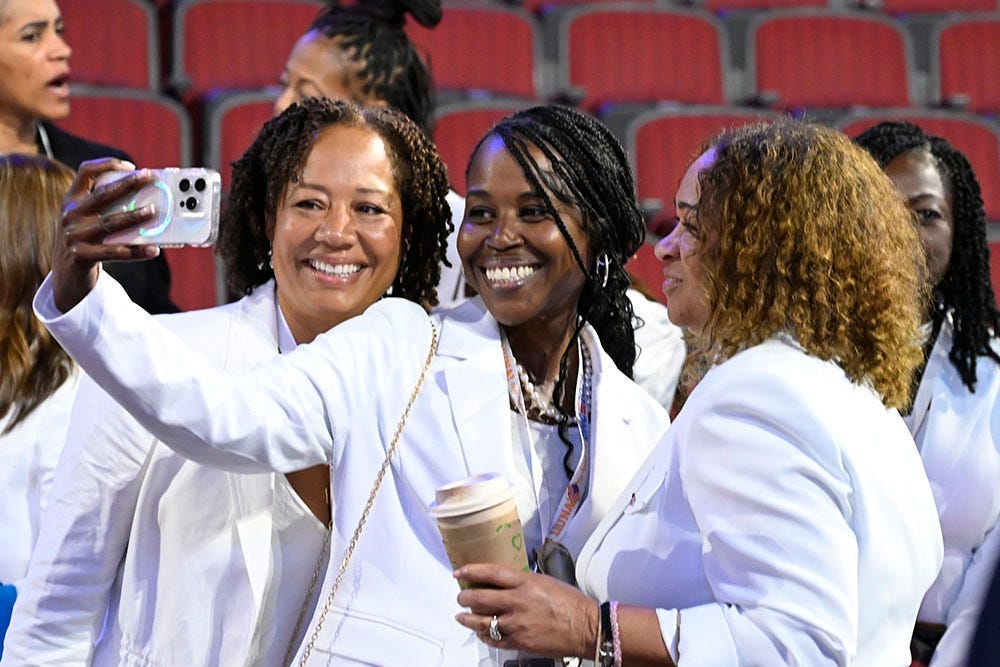 (L-R) Sherilyn Pruitt , Valerie Thomas and Tracye Donovan take a selfie on the floor before the start of the final day of the Democratic National Convention at the United Center on Aug 22, 2024. They are both part of a contingent of Howard University sorority sisters of Democratic Presidential nominee Vice President Kamala Harris at the convention.