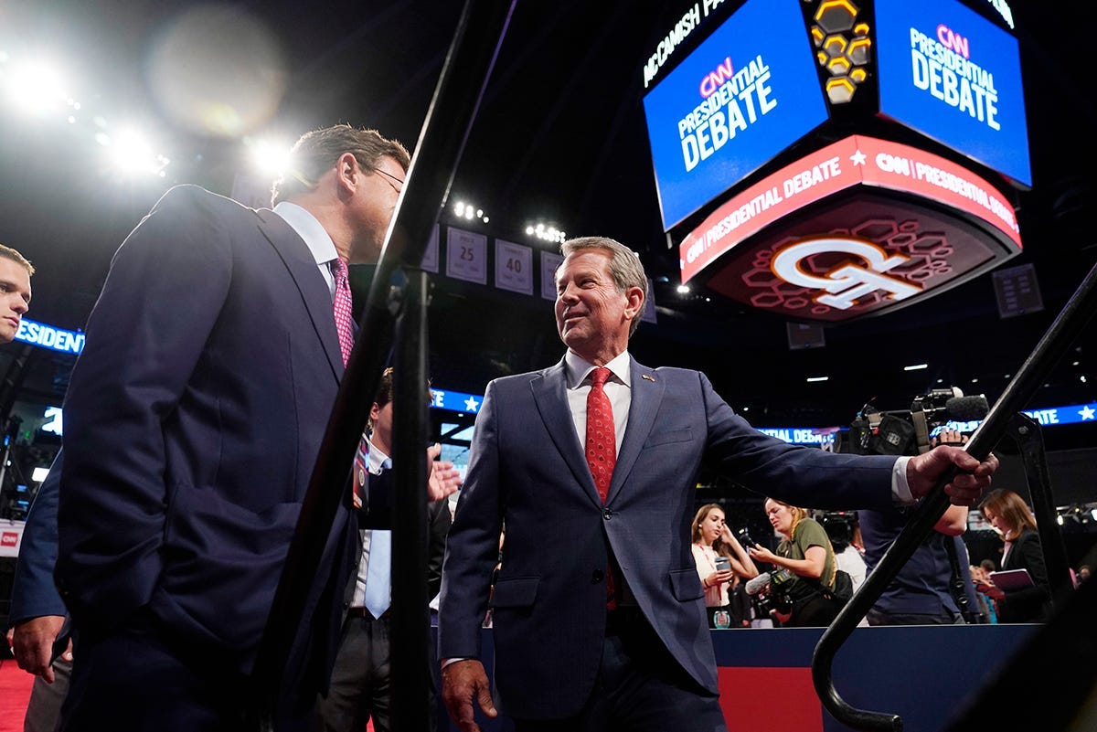 Georgia Republican Gov. Brian Kemp, right, speaking to the media before the debate between President Joe Biden and former President Donald Trump in Atlanta on June 27, 2024.