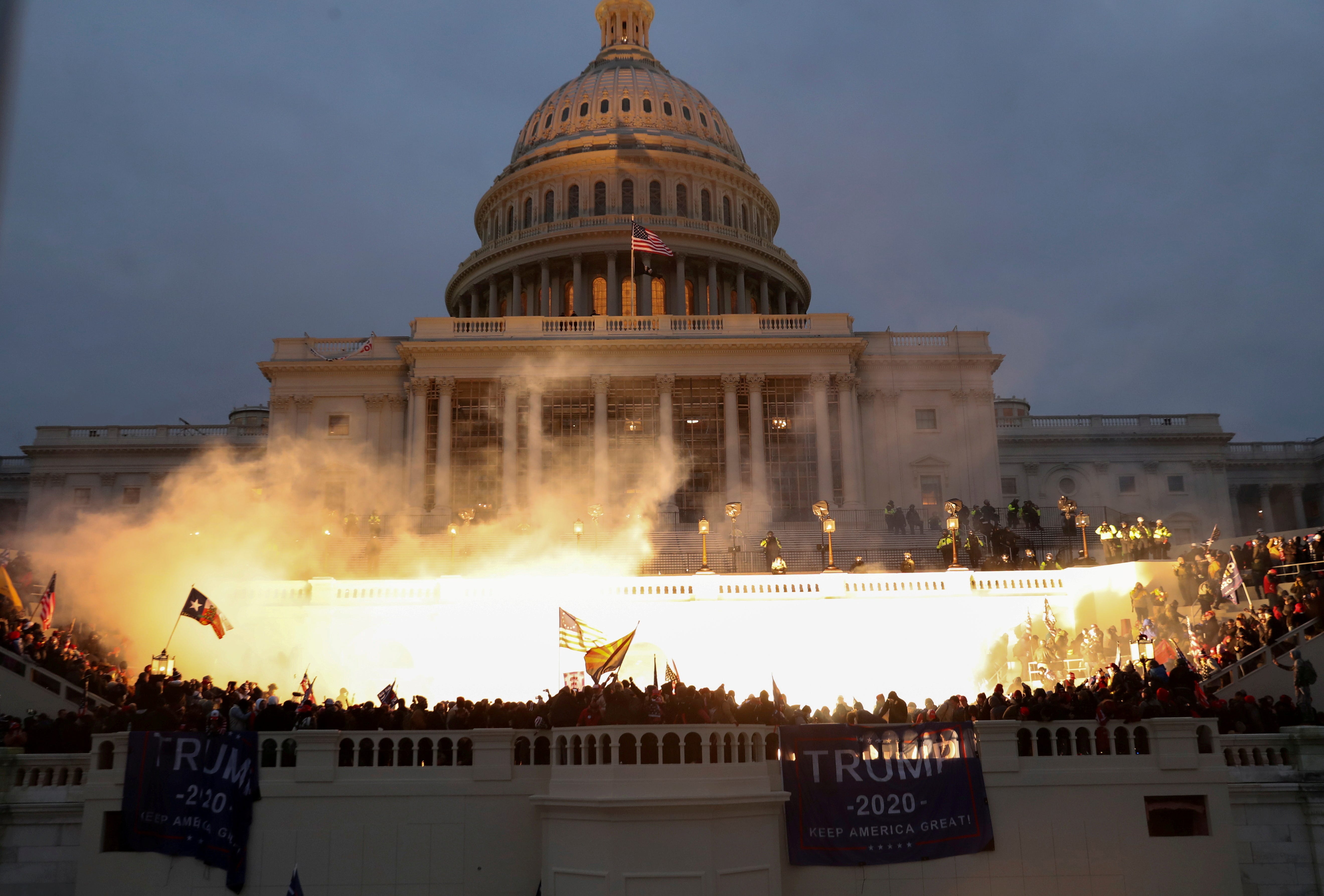 An explosion caused by a police munition is seen while supporters of U.S. President Donald Trump riot in front of the U.S. Capitol Building in Washington, U.S., January 6, 2021. Reuters photographer Leah Millis: "Thousands of supporters of then-President Donald Trump, a Republican, stormed the U.S. Capitol on Jan. 6 in a failed attempt to overturn the recent election and prevent Joe Biden, a   Democrat, from becoming the next president. It was the worst attack on the seat of the U.S. government since the War of 1812. I arrived at the west side of the U.S. Capitol before the Trump supporters overwhelmed police lines, and I documented the chaos that ensued for the next seven hours. At one point I heard the crowd chanting "heave-ho" and thought they must be breaking in through the doors. I didn't want to risk getting crushed or injured by the massive crowd, which was hostile toward members of the media and had already assaulted several of my colleagues that day. I chose to risk climbing some scaffolding that had been erected for the upcoming inauguration to give me a   better view. The Capitol had already been breached via different entrances, but the fight for this entrance went on for hours. Capitol and D.C. Metropolitan police officers engaged in hand-to-hand combat with the mob of Trump supporters and in the process multiple officers were severely injured. Four people would die that day and a police officer attacked by protesters died the next day. Four officers later took their own lives. Eventually, law enforcement was able to successfully push the crowd back. At 5:04 p.m. to disperse the remaining protesters, they used a flash-bang grenade, which released a blinding light that illuminated the U.S. Capitol building. To me, the explosion of the   grenade captured the violence and shock of the day: American citizens attacking and breaching their own country's Capitol building. The haunting sight of the American flag flying above the entire scene, casting a shadow onto