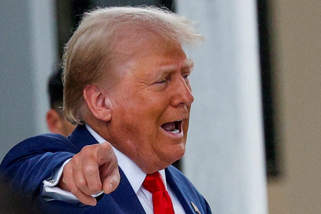 Republican presidential candidate and former U.S. President Donald Trump gestures as he leaves, after casting his ballot for early voting in Florida's primary election, in West Palm Beach, Florida on August 14, 2024.
