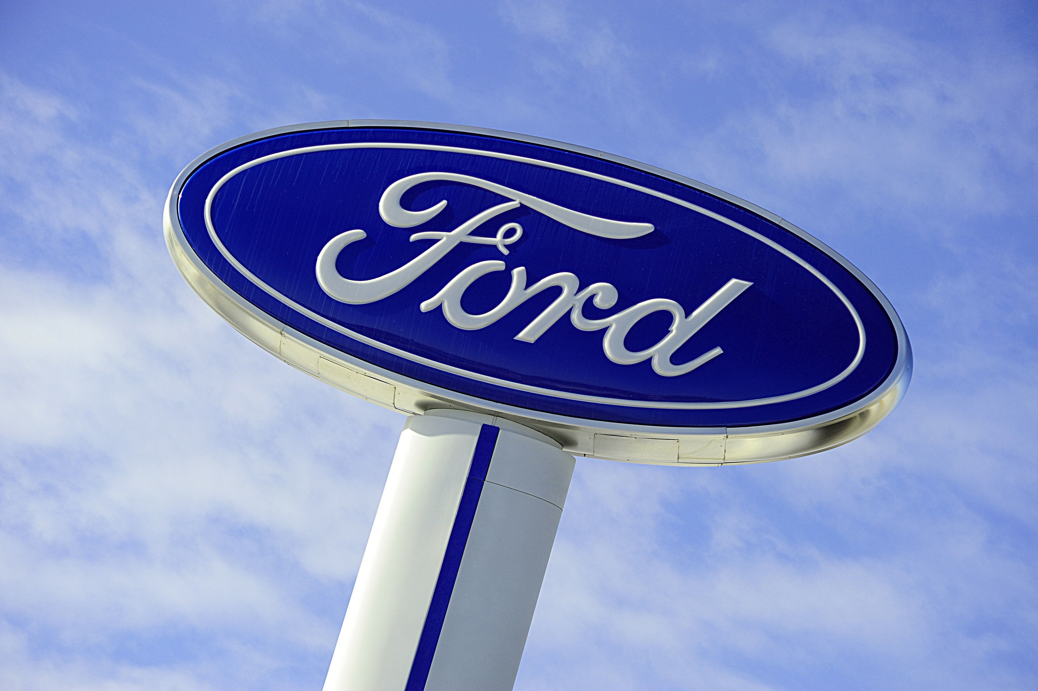 The Ford logo is seen on a sign at a dealership in Hudson, Wis.