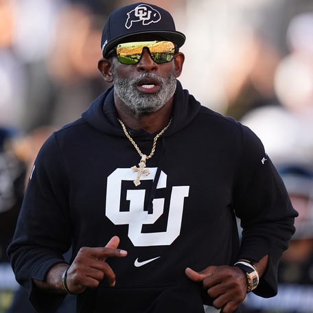 Colorado coach Deion Sanders runs onto the field before his team's game against North Dakota State at Folsom Field.