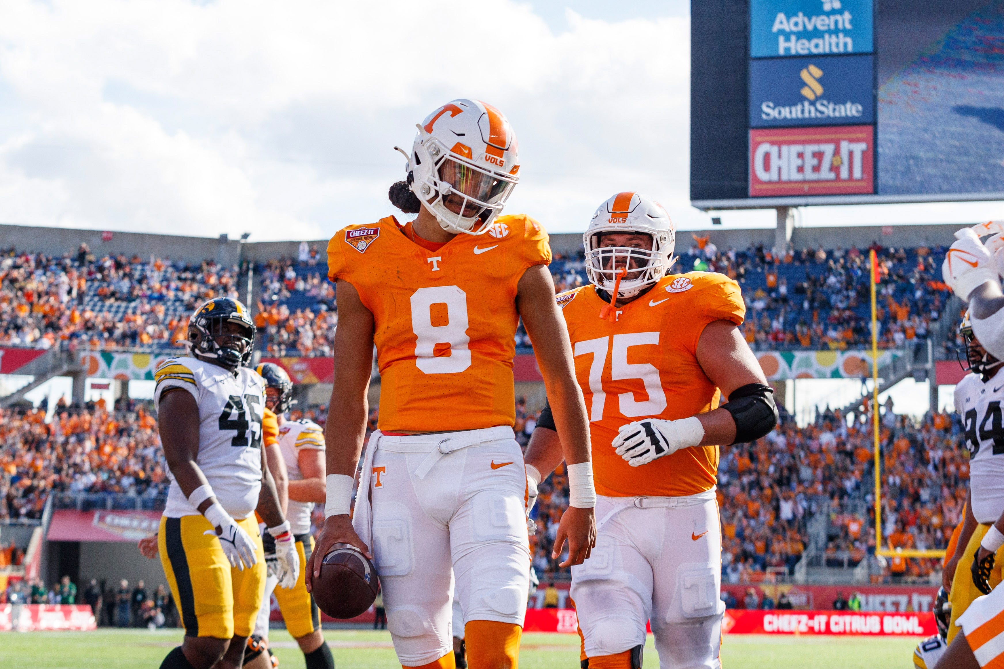 Tennessee quarterback Nico Iamaleava (8) scores a touchdown against Iowa during the 2024 Citrus Bowl at Camping World Stadium.