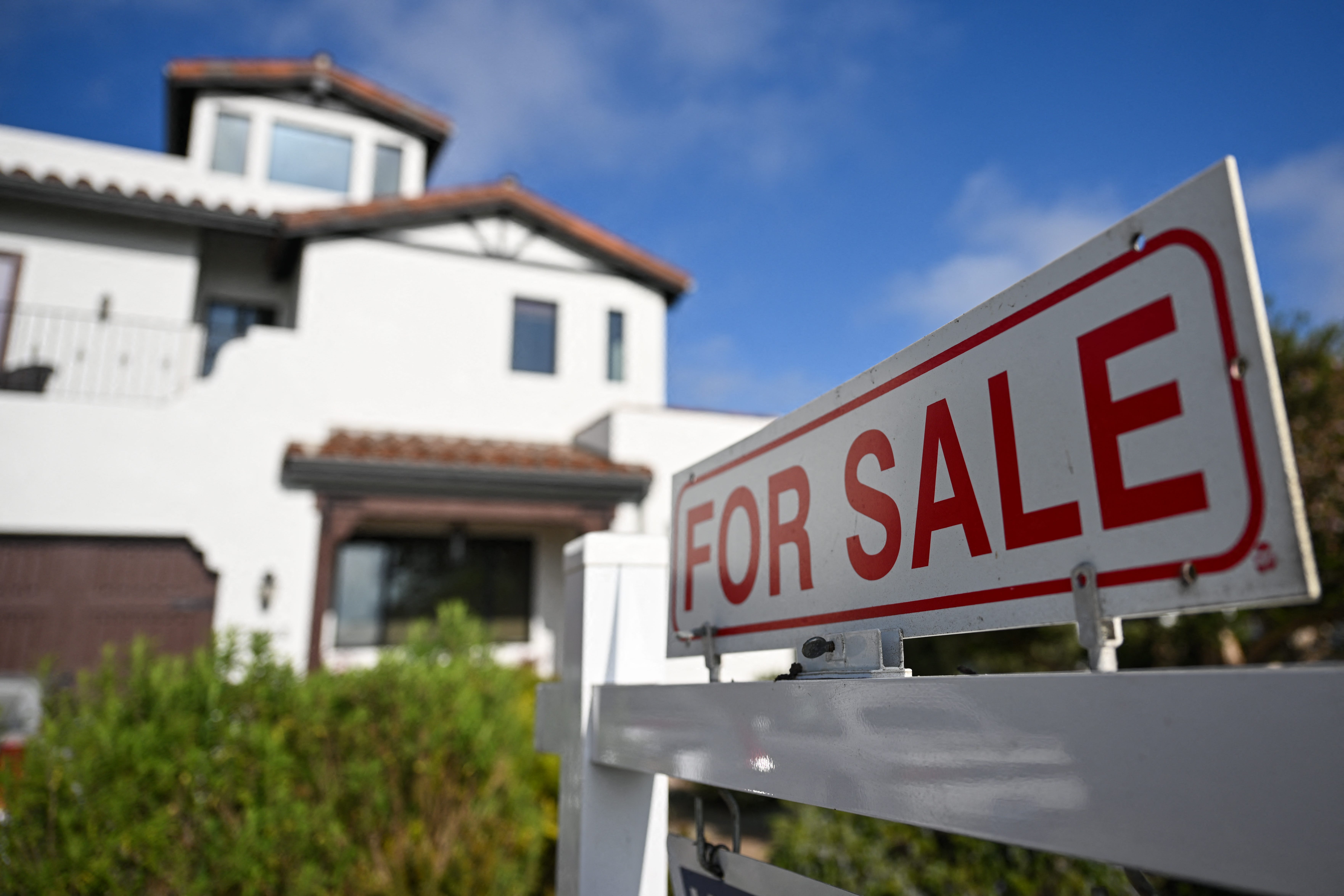 A for sale sign is displayed outside of a home for sale on Aug.16, 2024, in Los Angeles, California. Sales of previously owned homes in the United States edged up in July, industry data showed on Aug. 22, 2024, breaking a four-month trend of declines.