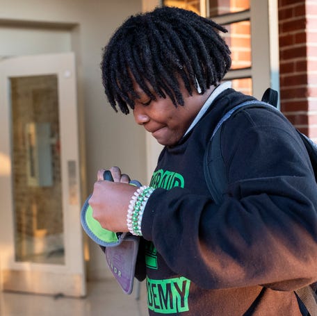Students store their cell phones in pouches as they arrive on Sept. 10, 2024, at Emerald Academy in Knoxville, Tennessee.