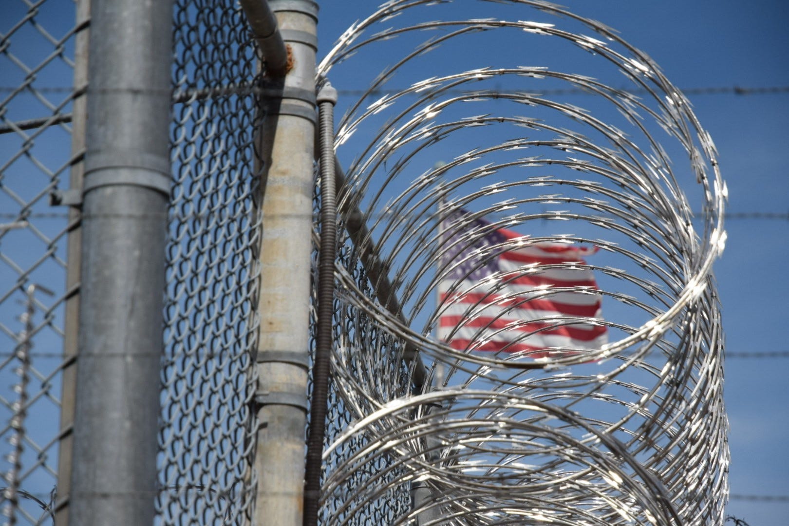 The American flag seen behind barbed wire at Holman Correctional Facility on Oct. 22, 2019.