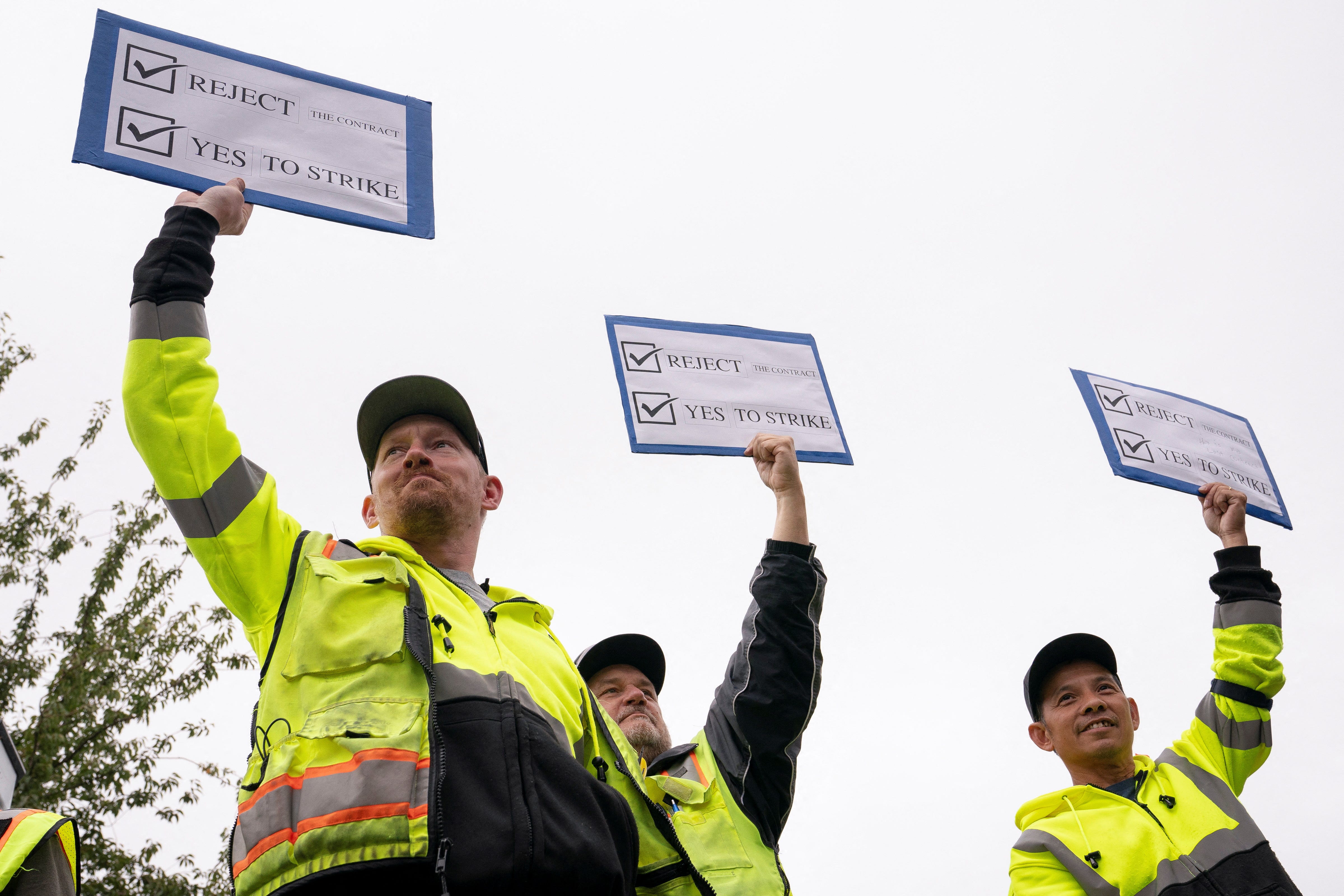 Boeing factory workers hold signs in support of a strike Thursday as they vote on their first full contract in 16 years, at an International Association of Machinists and Aerospace Workers District 751 union hall, in Renton, Washington.