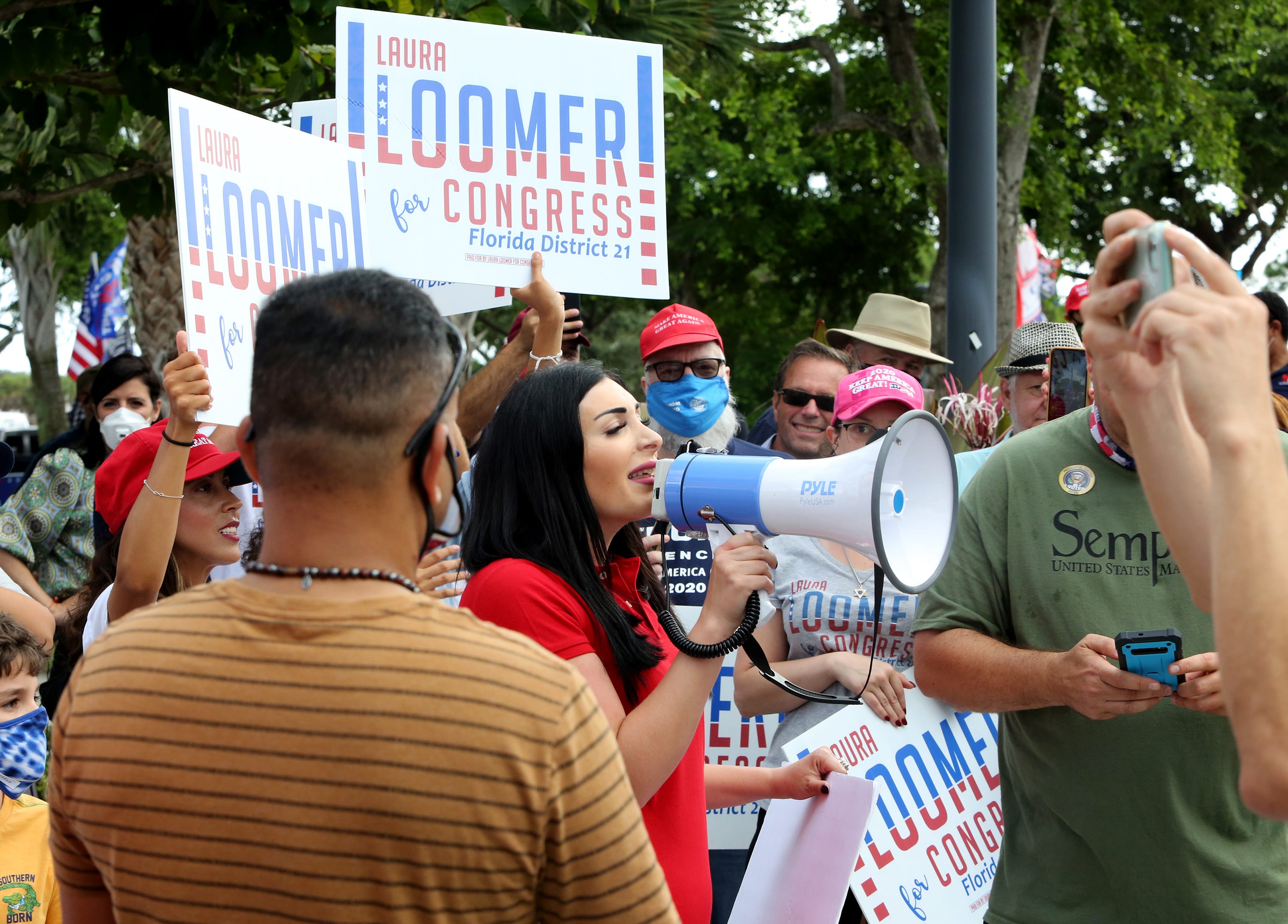 Laura Loomer addresses the crowd of voters as they wait to cast their votes and maybe a glimpse of President Trump as he arrives at the early voting polling station located at The Palm Beach County Library on Summit Blvd. in West Palm Beach.