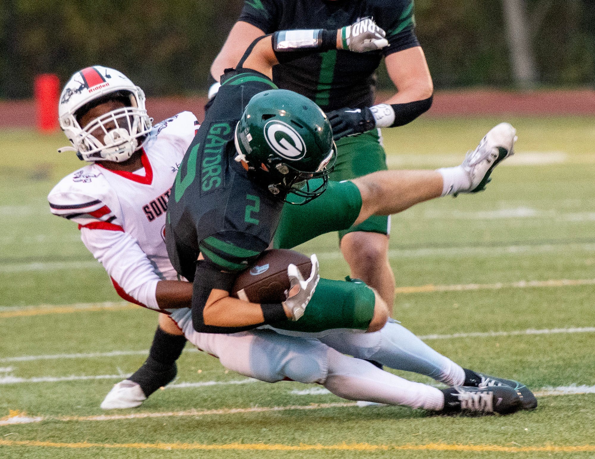 South’s Cyrus Johnson pulls Grafton’s Finn Gilmore off his feet Friday.