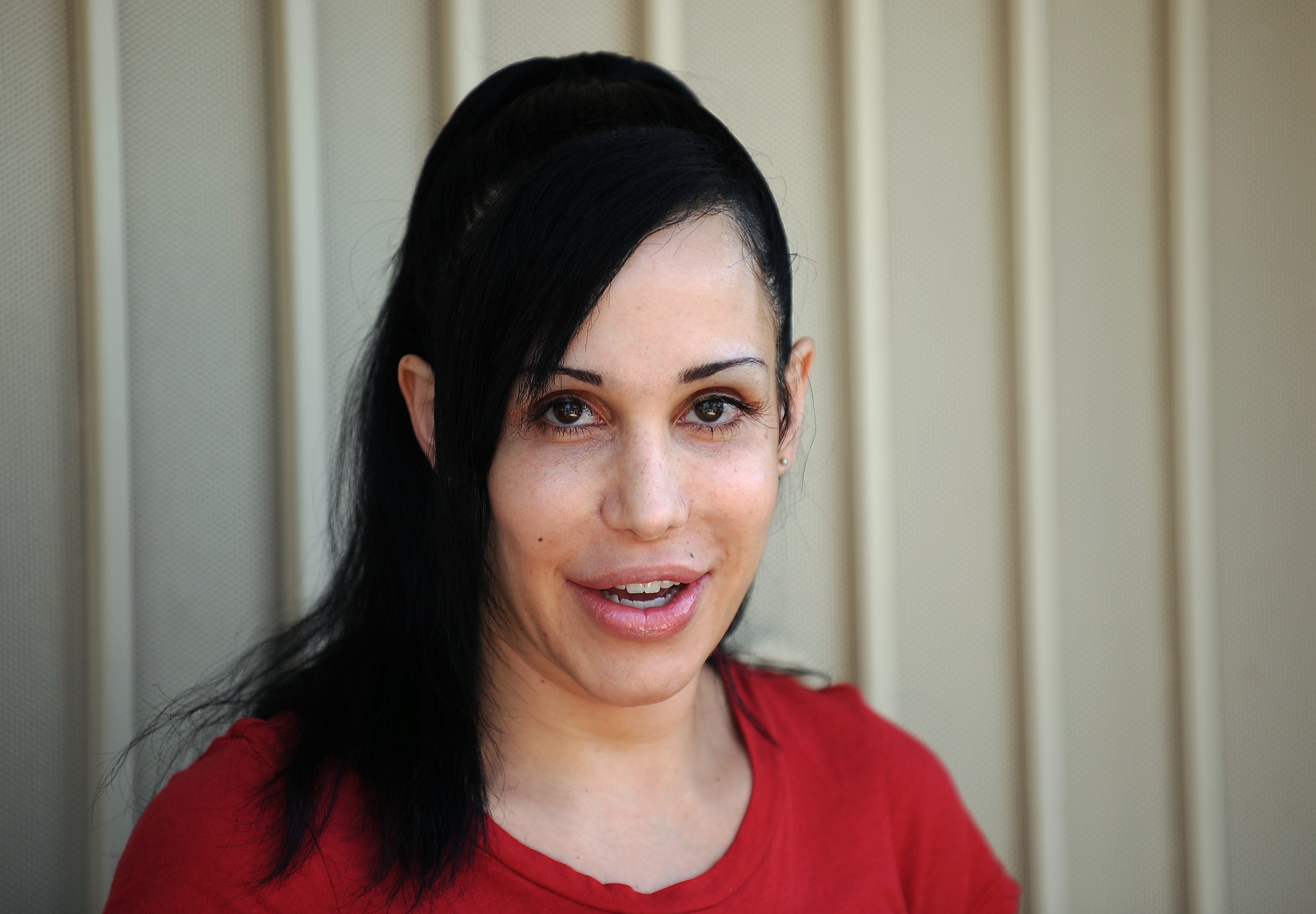 "Octomom" Nadya Suleman poses for photographers in front of her home in La Habra, California on May 19, 2010.
