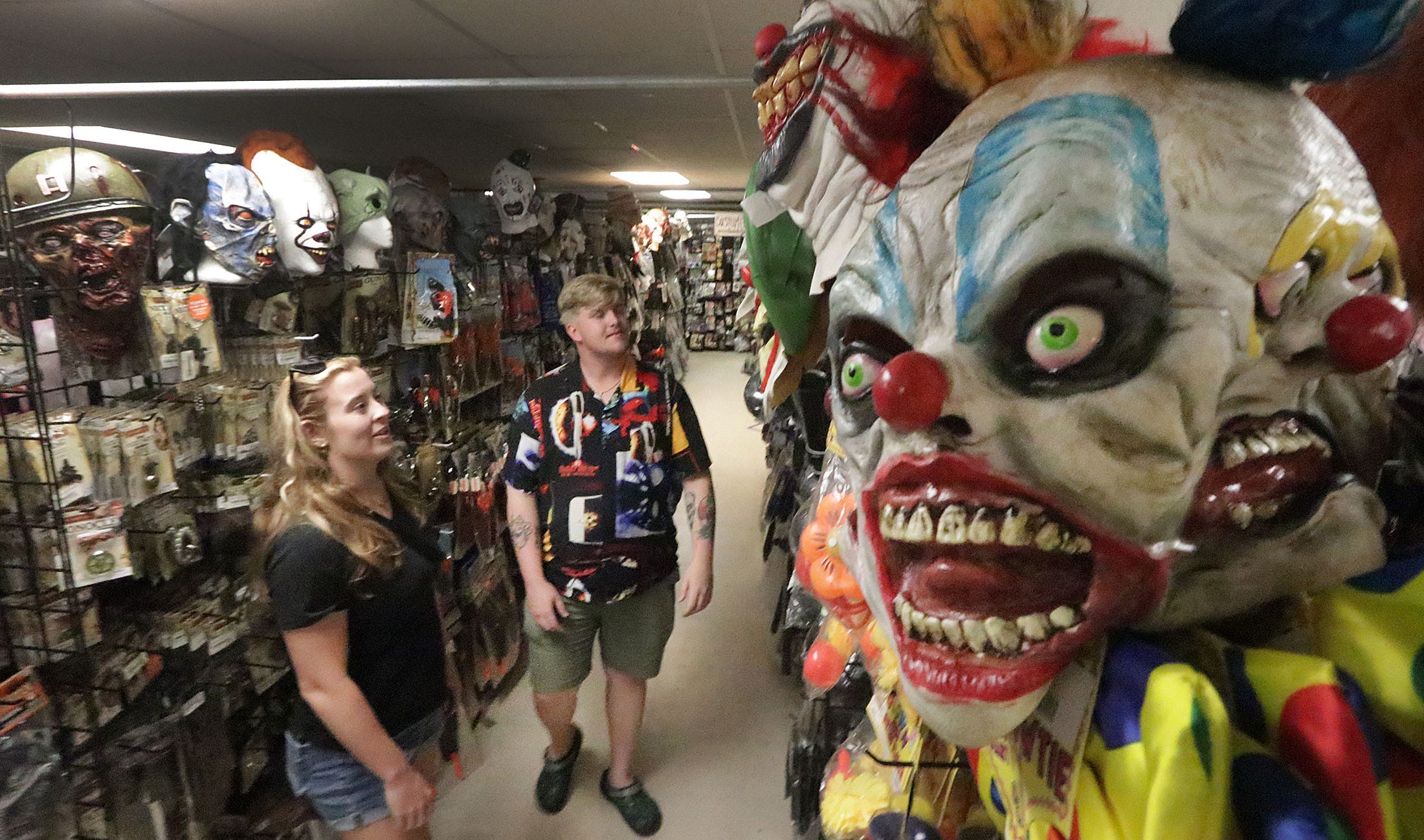 Customers look at hundreds of masks and other costumes on Sept. 20, 2024 at the Halloween Megastore in Daytona Beach, Florida.