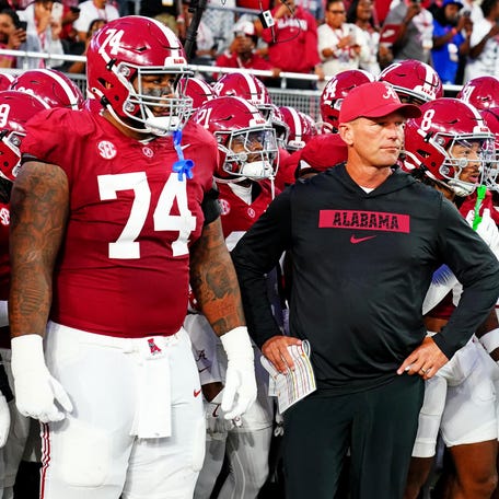 Alabama coach Kalen DeBoer leads his team onto the field before its game against Georgia at Bryant-Denny Stadium.