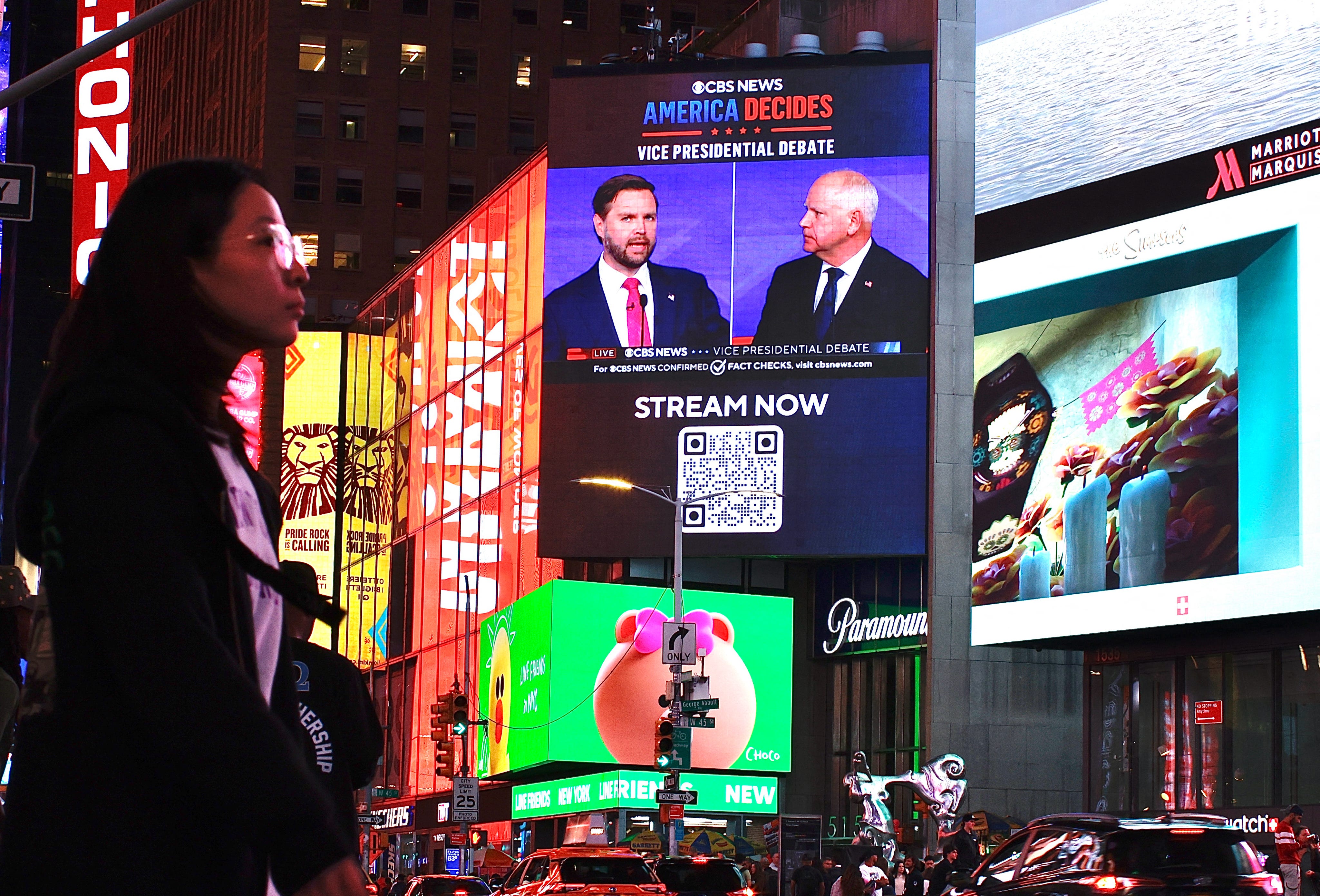 A screen displays the CBS vice presidential debate between US Senator and Republican vice presidential candidate J.D. Vance and Minnesota Governor and Democratic vice presidential candidate Tim Walz in Times Square in New York on October 1, 2024.