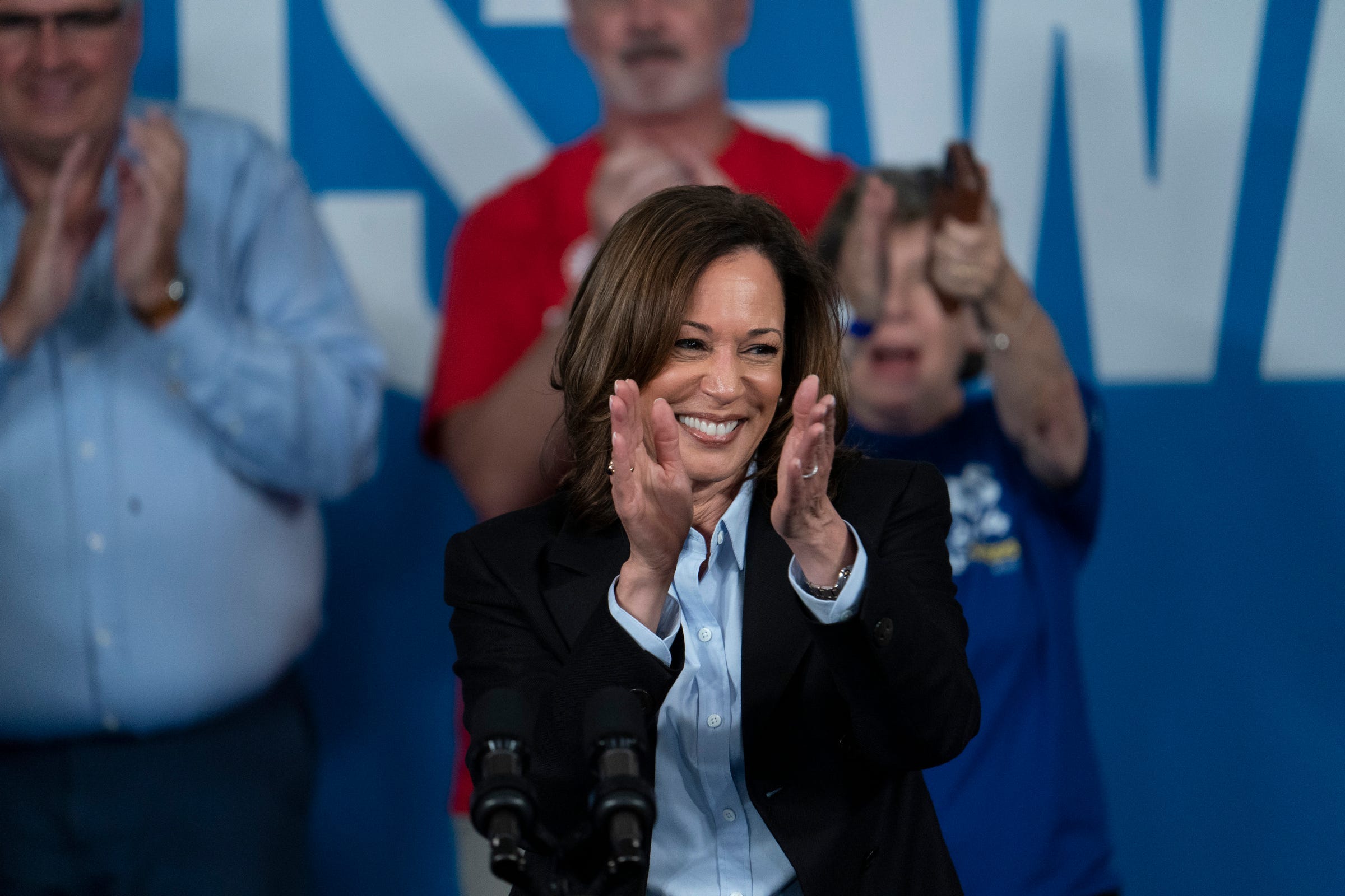 With labor and union representation in the background, including UAW President Shawn Fain, Vice President Kamala Harris speaks at Northwestern High School in Detroit during a Labor Day rally on Monday, Sept. 2, 2024.
