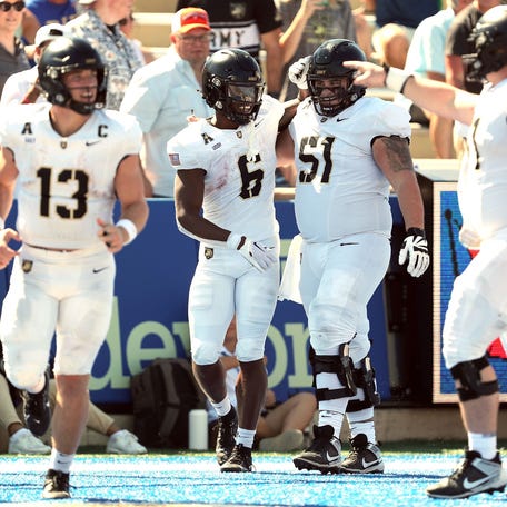 Army running back Kanye Udoh (6) celebrates his touchdown with center Brady Small (51) against Tulsa during the second half on Oct. 5, 2024.