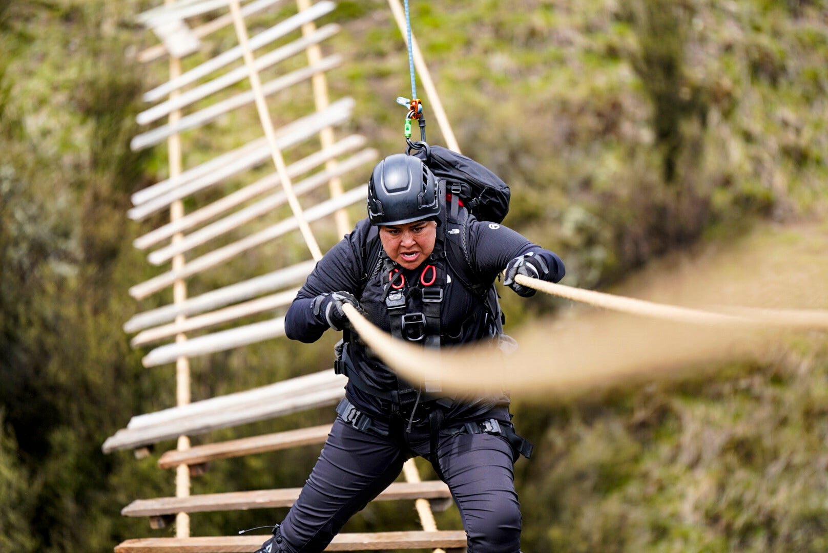 Los Angeles barber Pati Arana, 37, navigates at a rickety bridge in season 1 episode 2 of CBS reality competition series "The Summit."