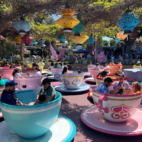 Guests giggle and spin on Disneyland's Mad Tea Party.