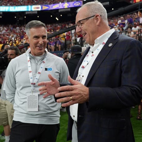 Big Ten commissioner Tony Petitti, left, and SEC commissioner Greg Sankey attend the game between LSU and Southern California at Allegiant Stadium.