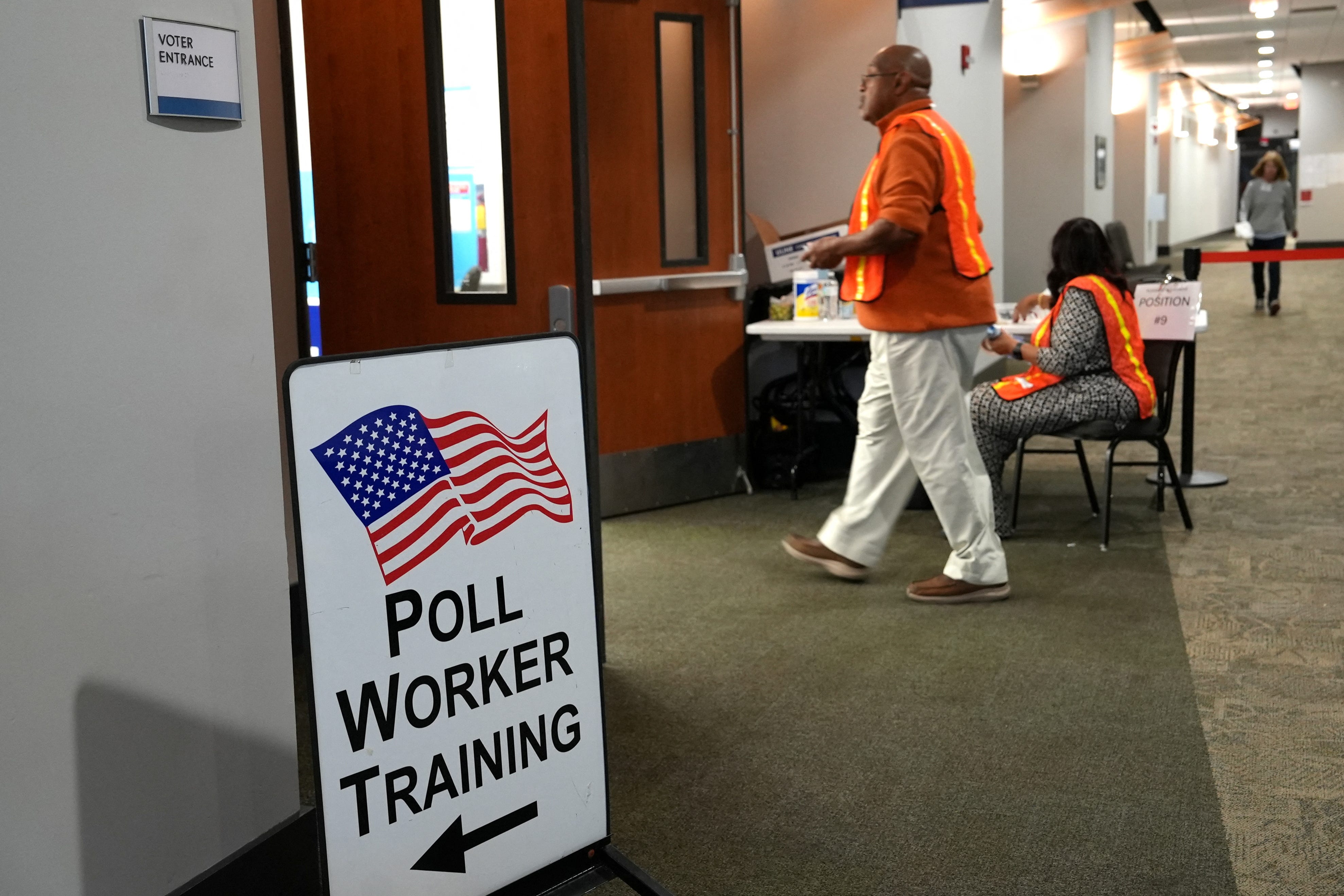 Election workers oversee early election voting at a polling station in Marietta, Georgia on October 15, 2024.