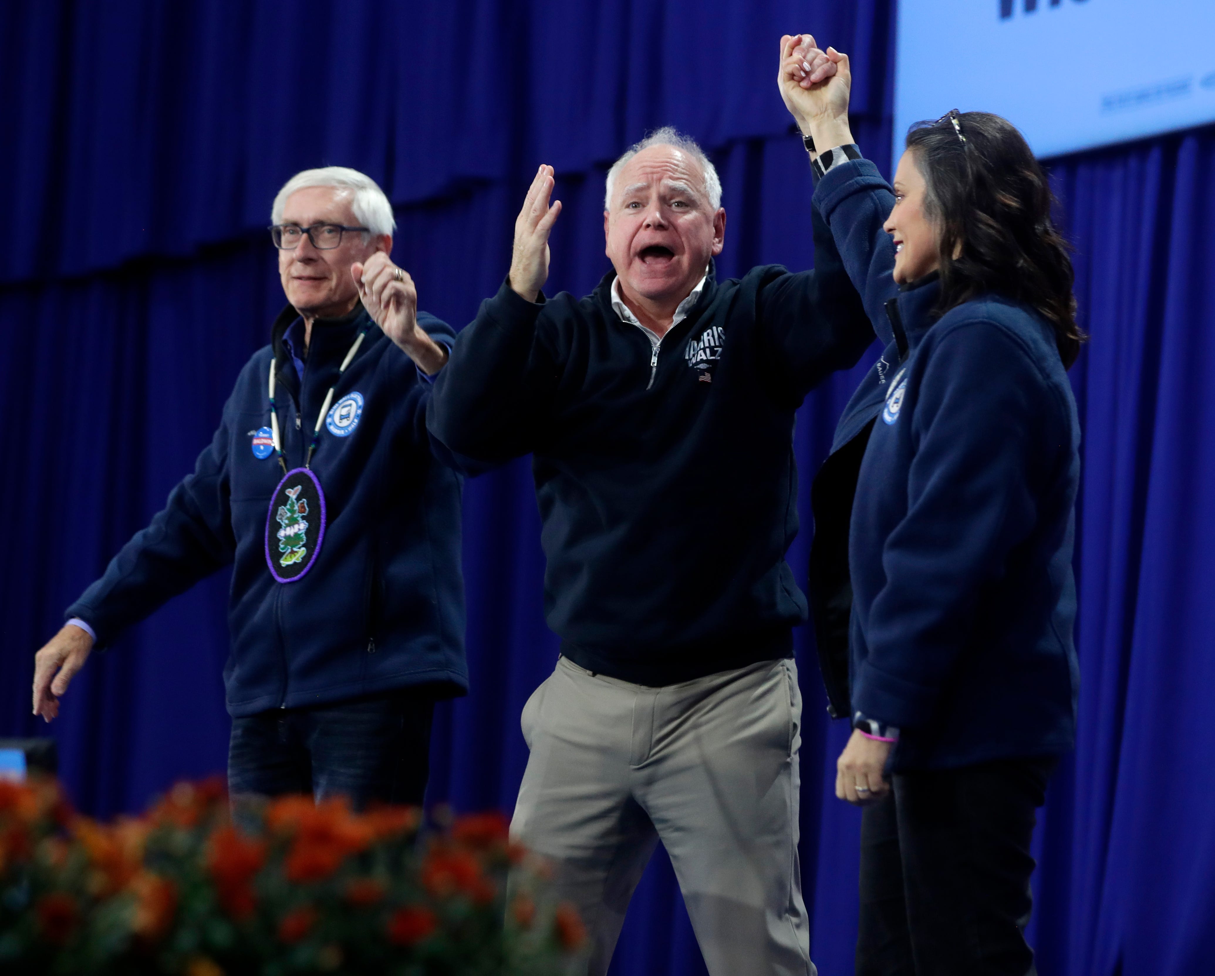 Democratic vice presidential nominee Tim Walz, center, with Michigan Gov. Gretchen Whitmer and Wisconsin Gov. Tony Evers, thanks the crowd during a campaign rally on Oct. 14, 2024, in Green Bay, Wis.