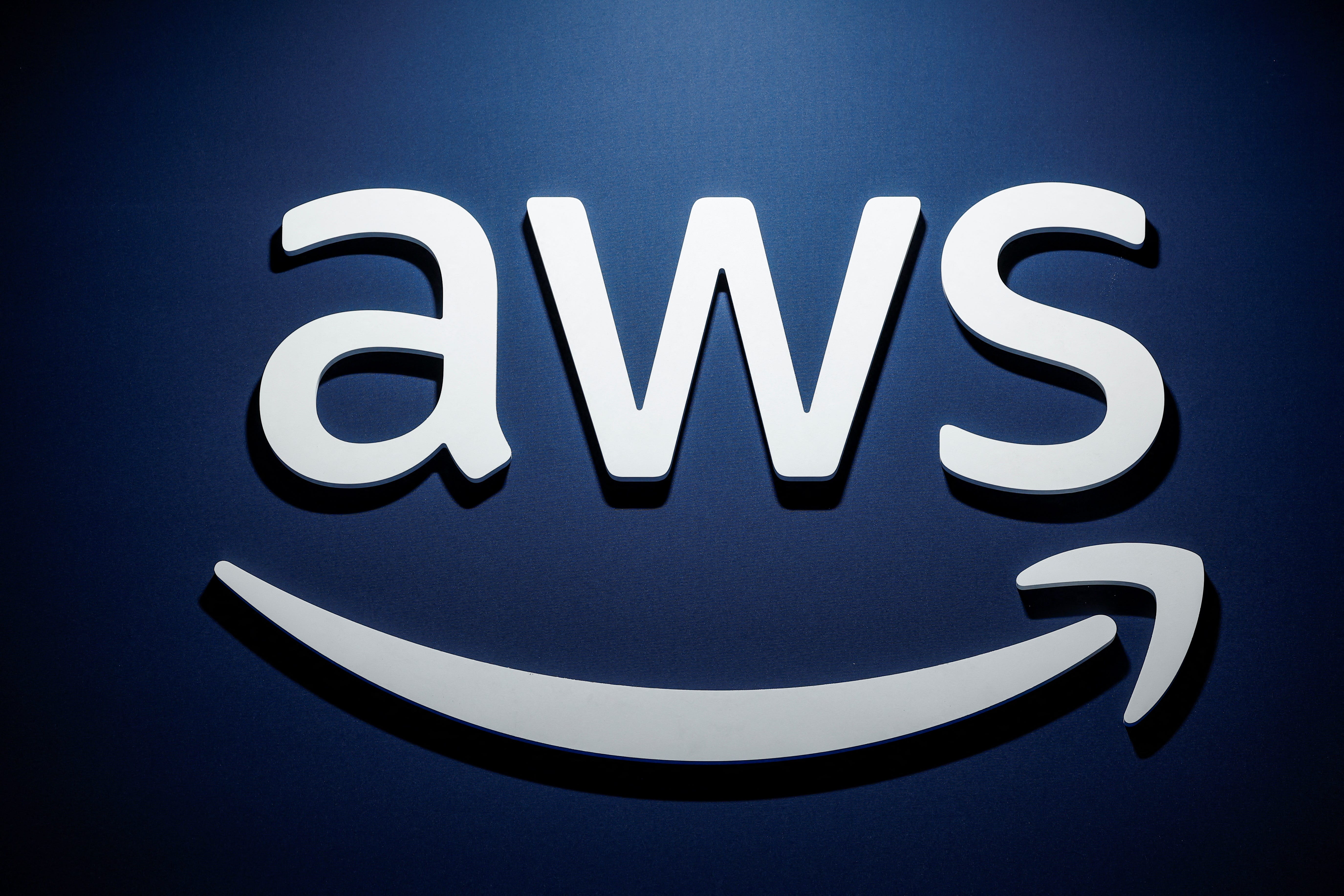 A logo for Amazon Web Services (AWS) is seen during the KubeCon + CloudNativeCon Europe hosted by the Cloud Native Computing Foundation (CNCF) in Paris, France, March 20, 2024.