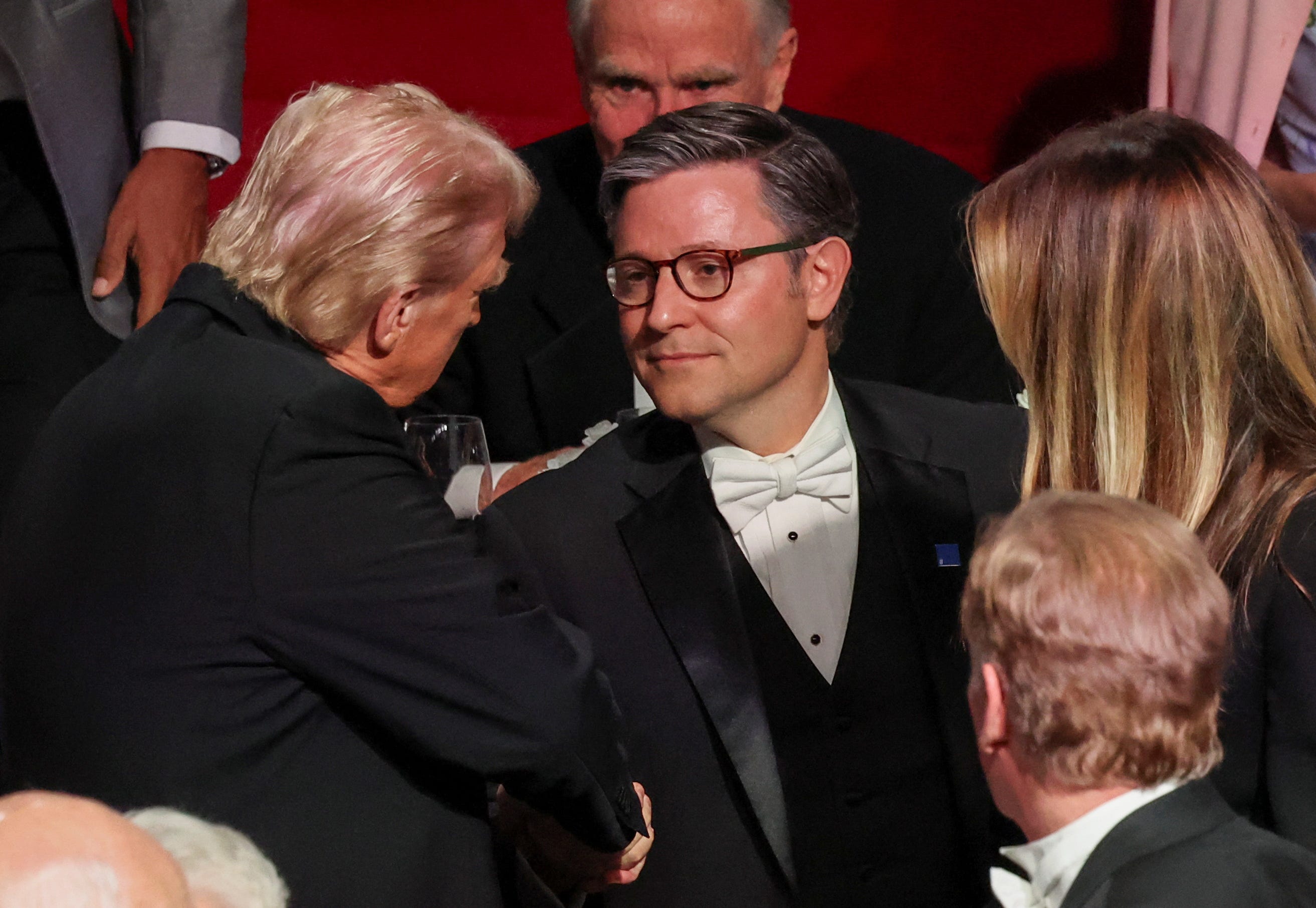 Republican presidential nominee former U.S. President Donald Trump greets Mike Johnson, Speaker of the House, at the 79th annual Alfred E. Smith Memorial Foundation Dinner in New York City, U.S., October 17, 2024. REUTERS/Brendan McDermid