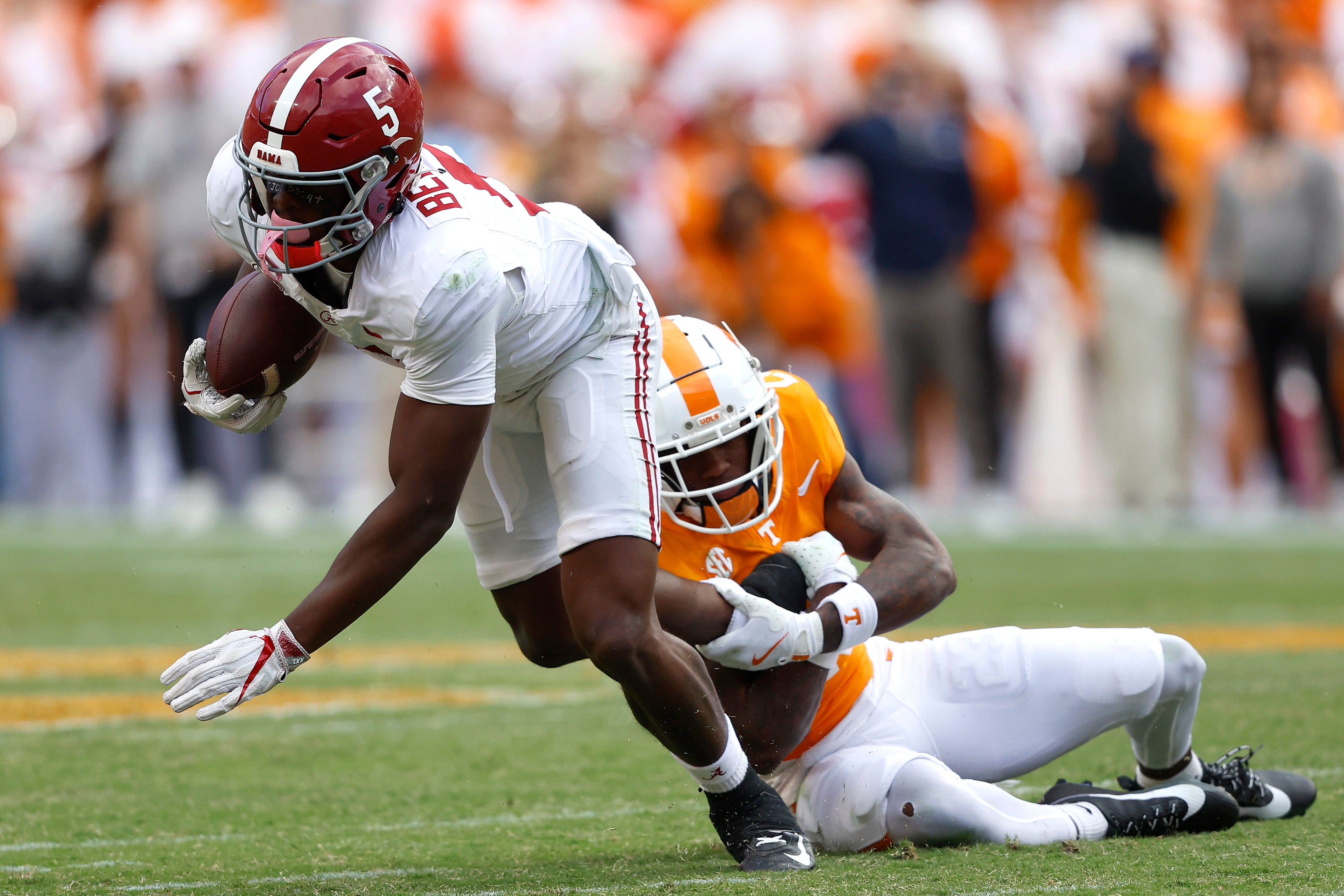 Alabama wide receiver Germie Bernard is tackled by Tennessee defensive back Boo Carter during the second quarter at Neyland Stadium on October 19, 2024 in Knoxville, Tenn.
