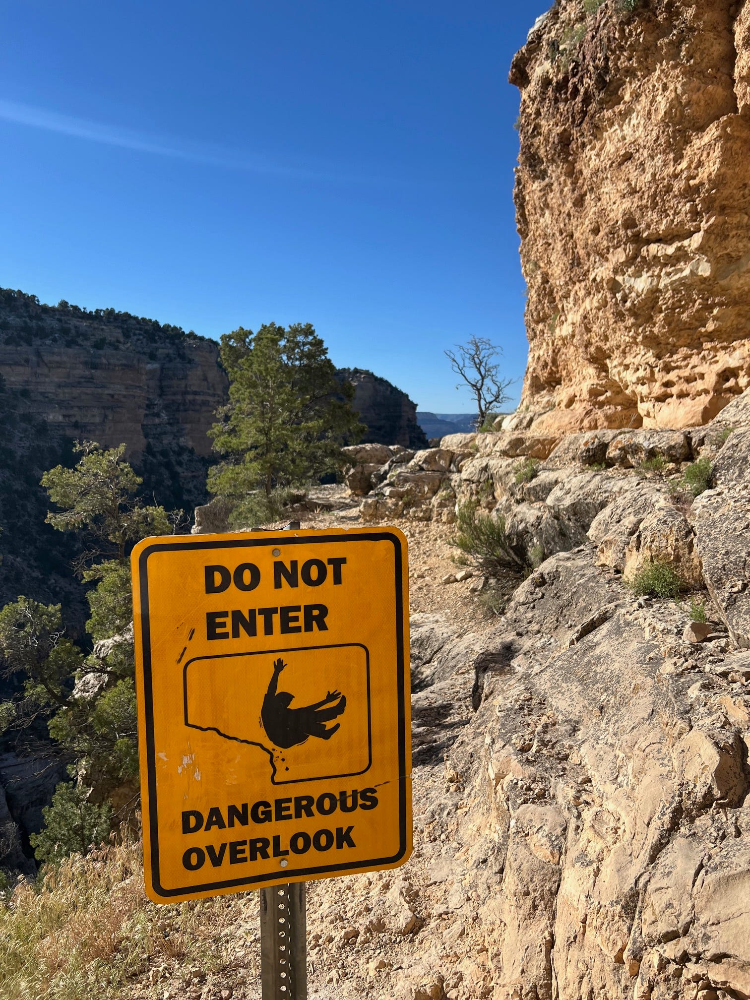 Signage warns visitors to stay away from an unsafe overlook along Grand Canyon National Park's Bright Angel Trail.