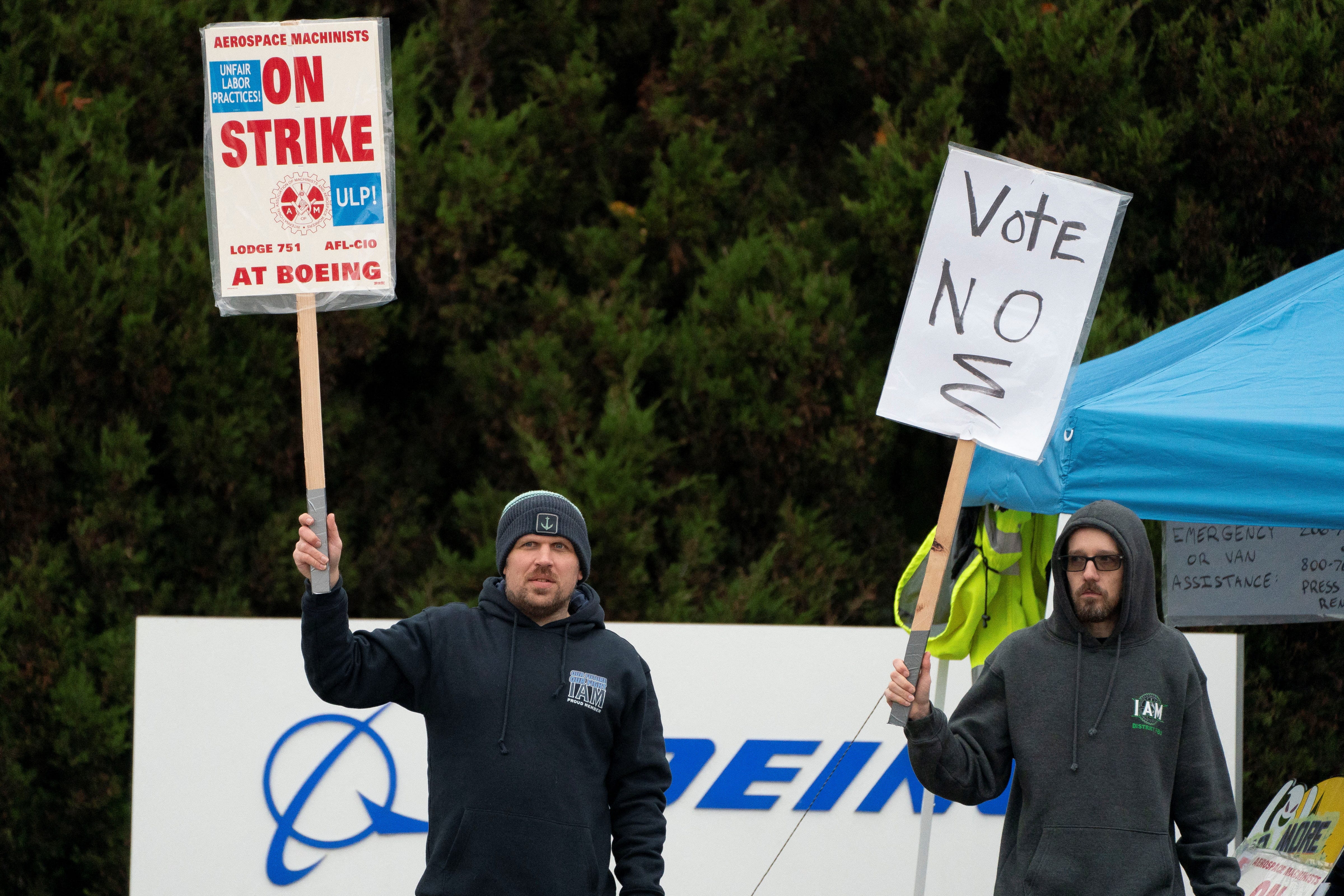 Boeing workers from the International Association of Machinists and Aerospace Workers District 751 gather on a picket line near the entrance to a Boeing production facility on the day of a vote on a new contract proposal during an ongoing strike in Renton, Washington, U.S. October 23, 2024.
