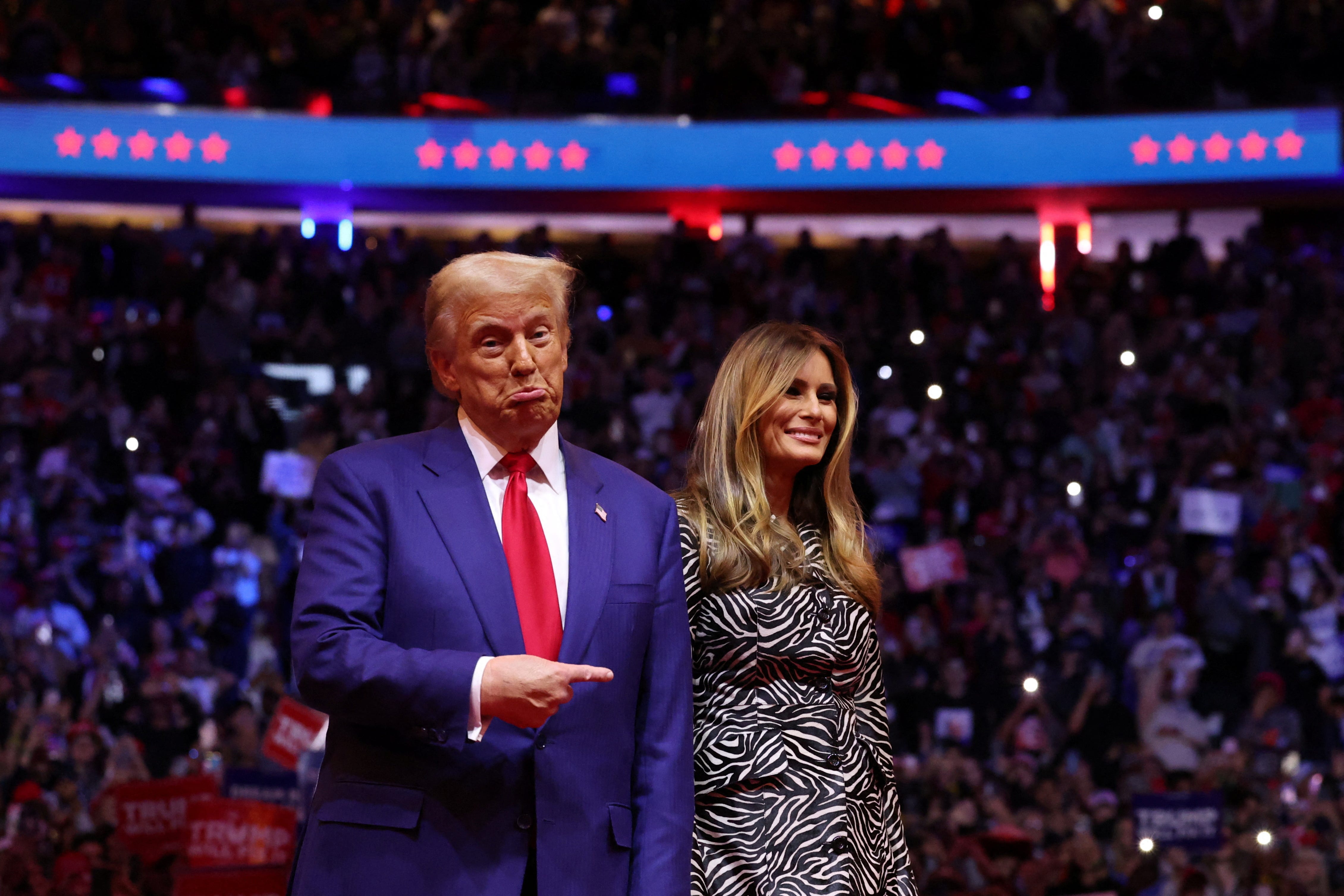 Republican presidential nominee and former U.S. President Donald Trump points his finger next to Melania Trump during a campaign rally at Madison Square Garden, in New York, U.S., October 27, 2024.