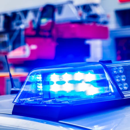 Blue Flash Light Of Police Car Against Red Fire Truck