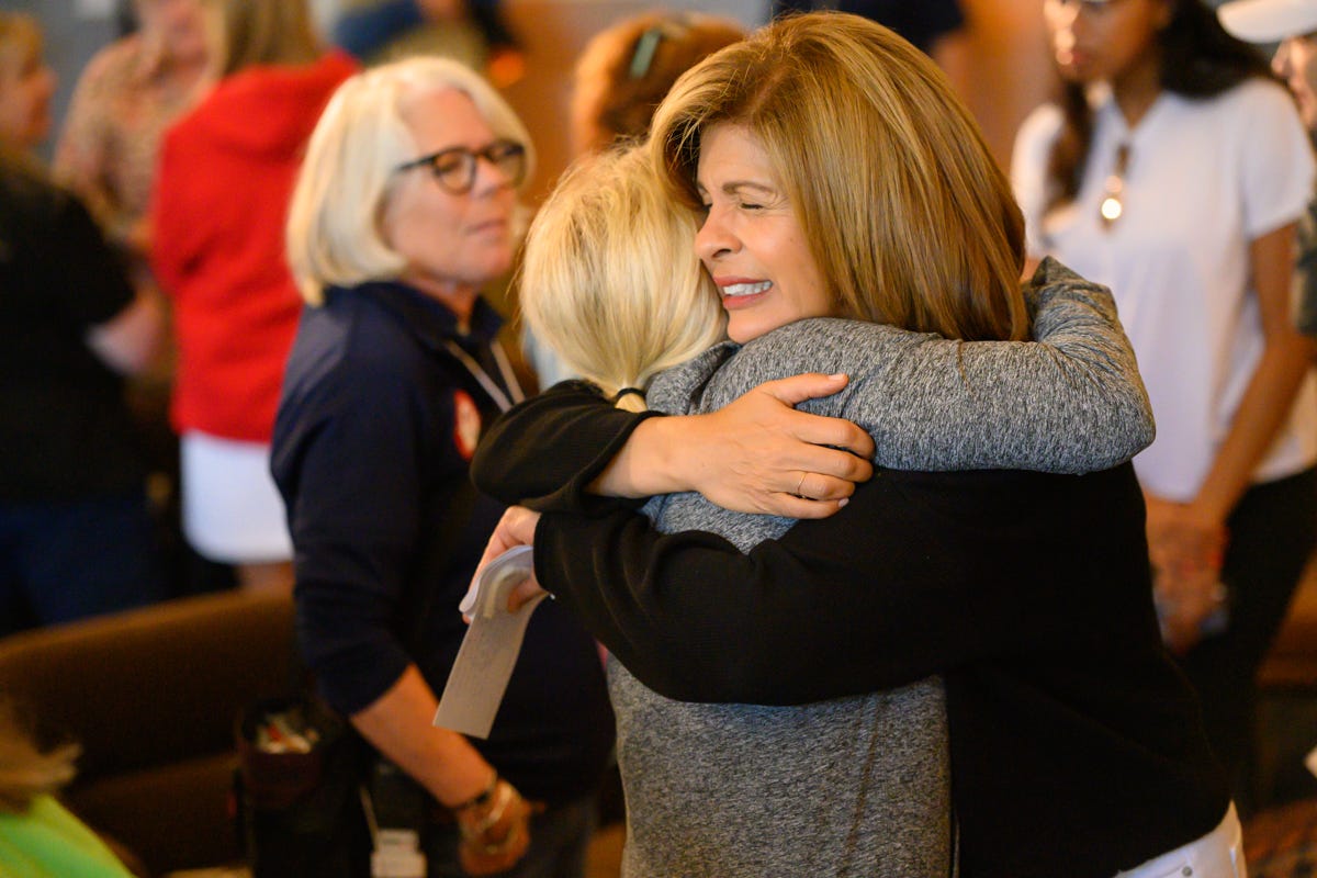 "Today" anchor Hoda Kotb tightly embraces an attendee at Making Space: A Wellness Weekend.